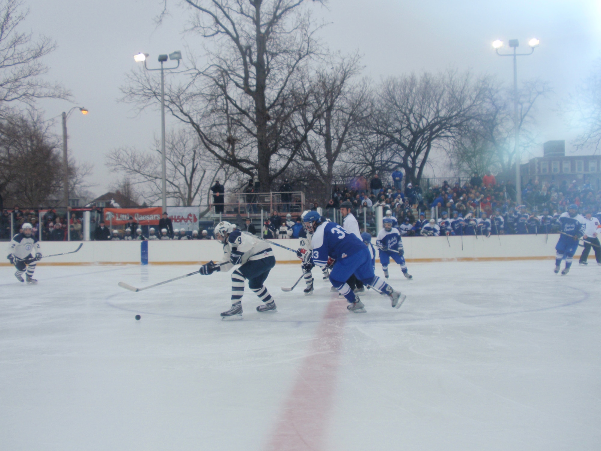 Detroit Catholic Central in blue and Bloomfield Hills Cranbrook Kingswood in white battle in the second period of the Detroit Outdoor Classic, part of the Great American Rivalry Series hockey game. (U.S. Air Force photo/ Tech Sgt. Michael Lionberger)