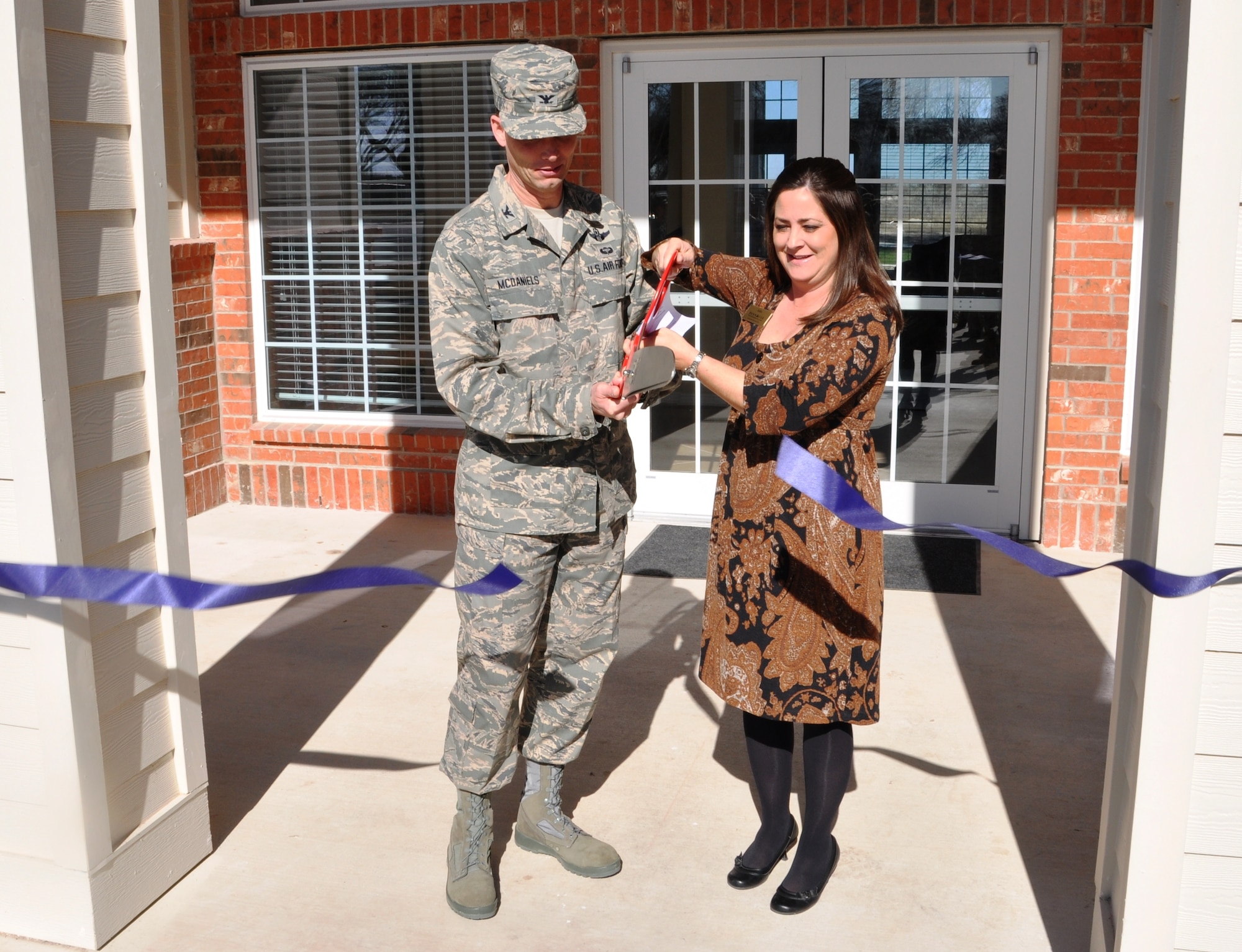 LAUGHLIN AIR FORCE BASE, Texas – Col. Jeffrey McDaniels, 47th Flying Training Wing commander, and Julie Akers, of Pinnacle, cut the ceremonial ribbon to symbolize the opening of the new Landings at Laughlin building at 8550 Edwards St. here Jan. 26. The building is the new home of the Pinnacle office and will be available for residents to have parties and other functions. (U.S. Air Force photo by Airman 1st Class Blake Mize) 
