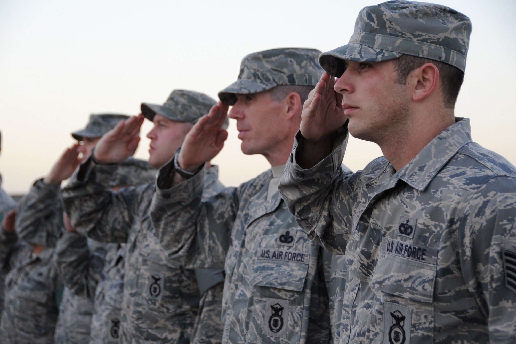 Members of the 380th Air Expeditionary Wing salute during retreat at an undisclosed location in Southwest Asia on Jan. 29, 2010.  Airmen from across the wing join every week to pay respect during retreat. (U.S. Air Force photo/Senior Airman Jenifer H. Calhoun/Released)
