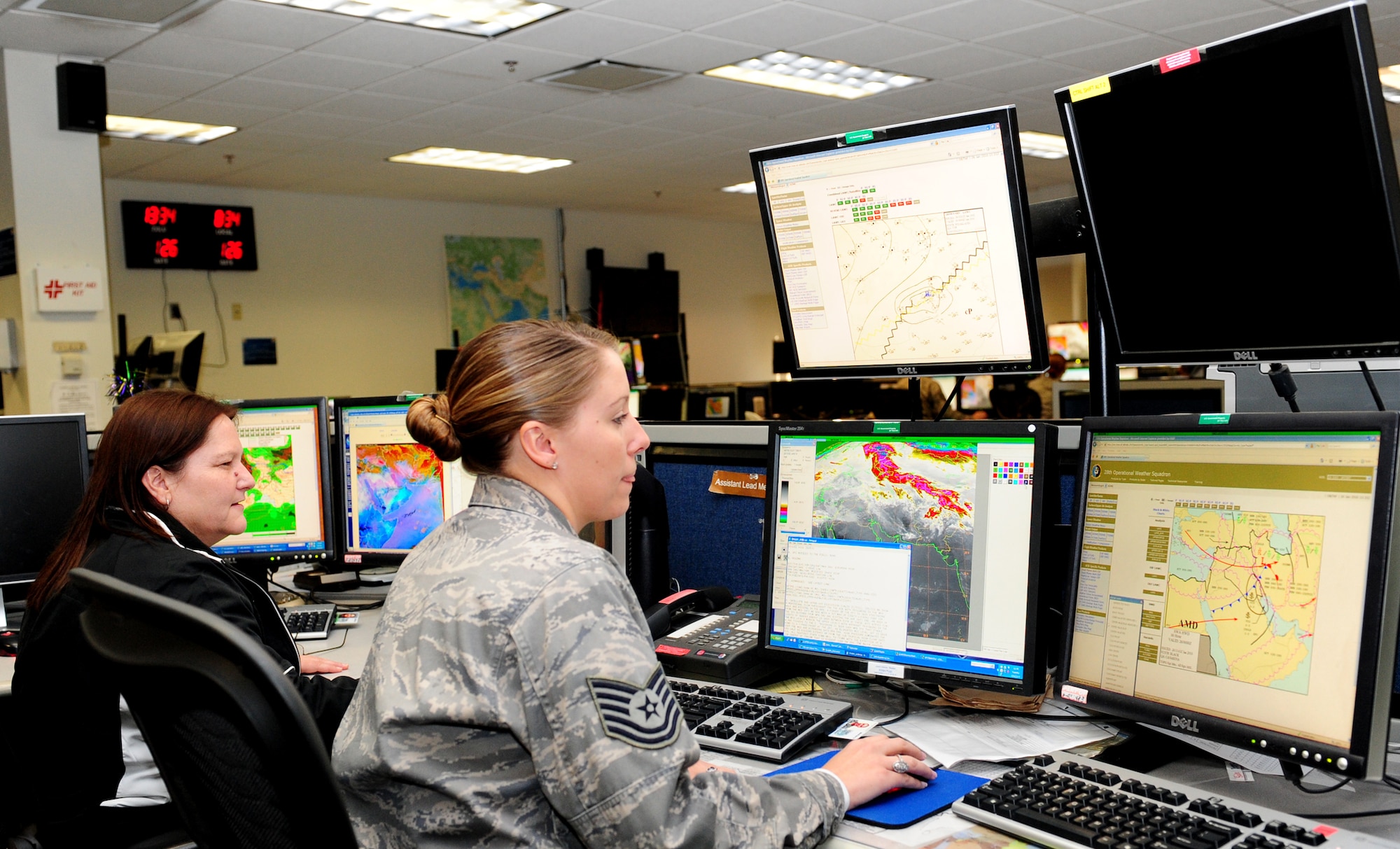 SHAW AIR FORCE BASE, S.C. -- Laura Stiverson (left) and Tech. Sgt. Casey Grim, 28th Operational Weather Squadron lead meteorologists, observe weather conditions in the Middle East Jan. 26.  As a part of the new intelligence, surveillance and reconnaissance cell, observations are used to produce weather forecasts to assist mission planning for unmanned aerial systems. (U.S. Air Force photo/2nd Lt.Tony Richardson)