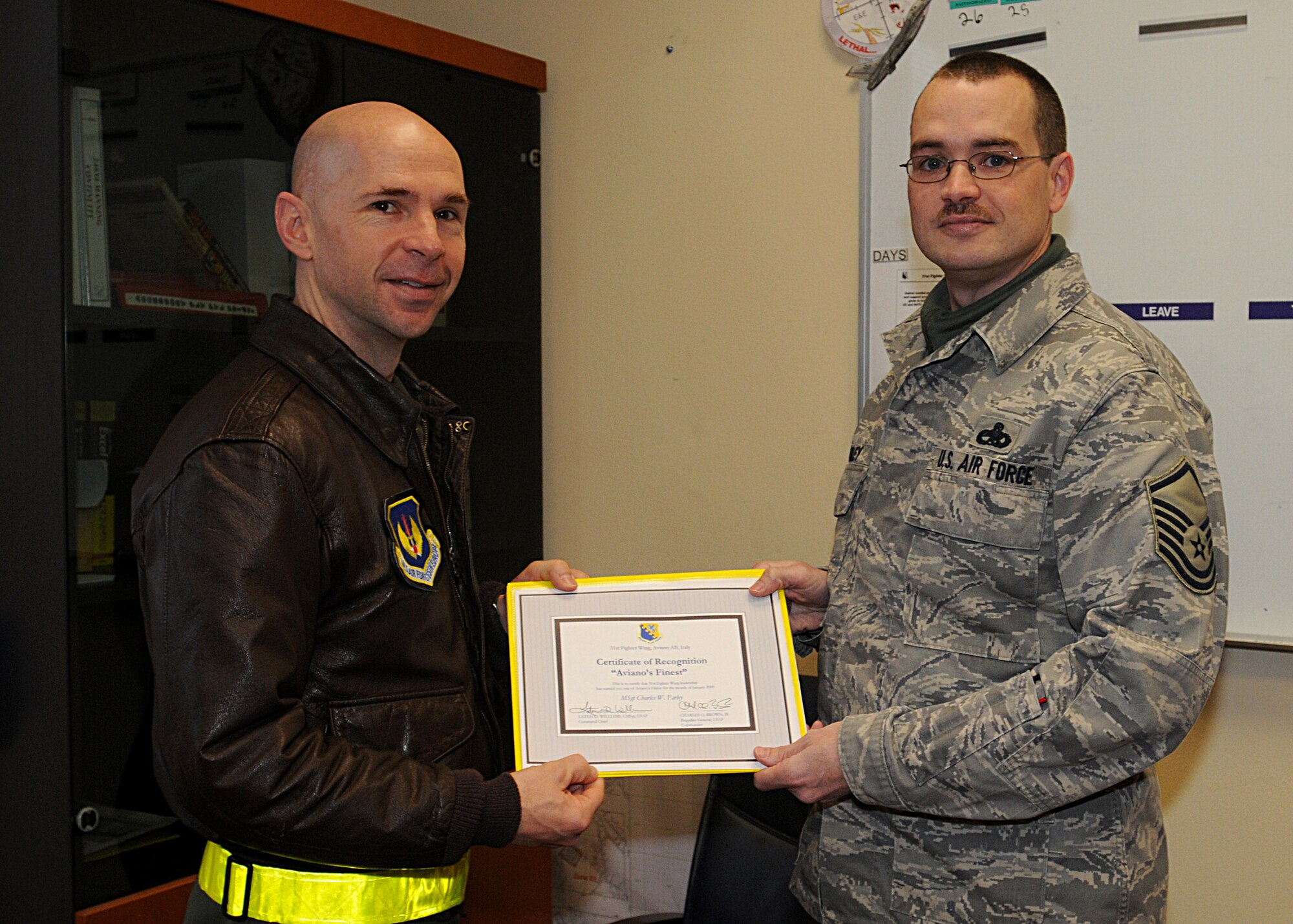 Colonel Patrick McClelland, 31st Fighter Wing vice commander, congratulates Master Sgt. Charles Farley, 31st Maintenance Squadron, on his selection as one of Aviano's Finest.  (U.S. Air Force photo/Senior Airman Tabitha M. Mans)