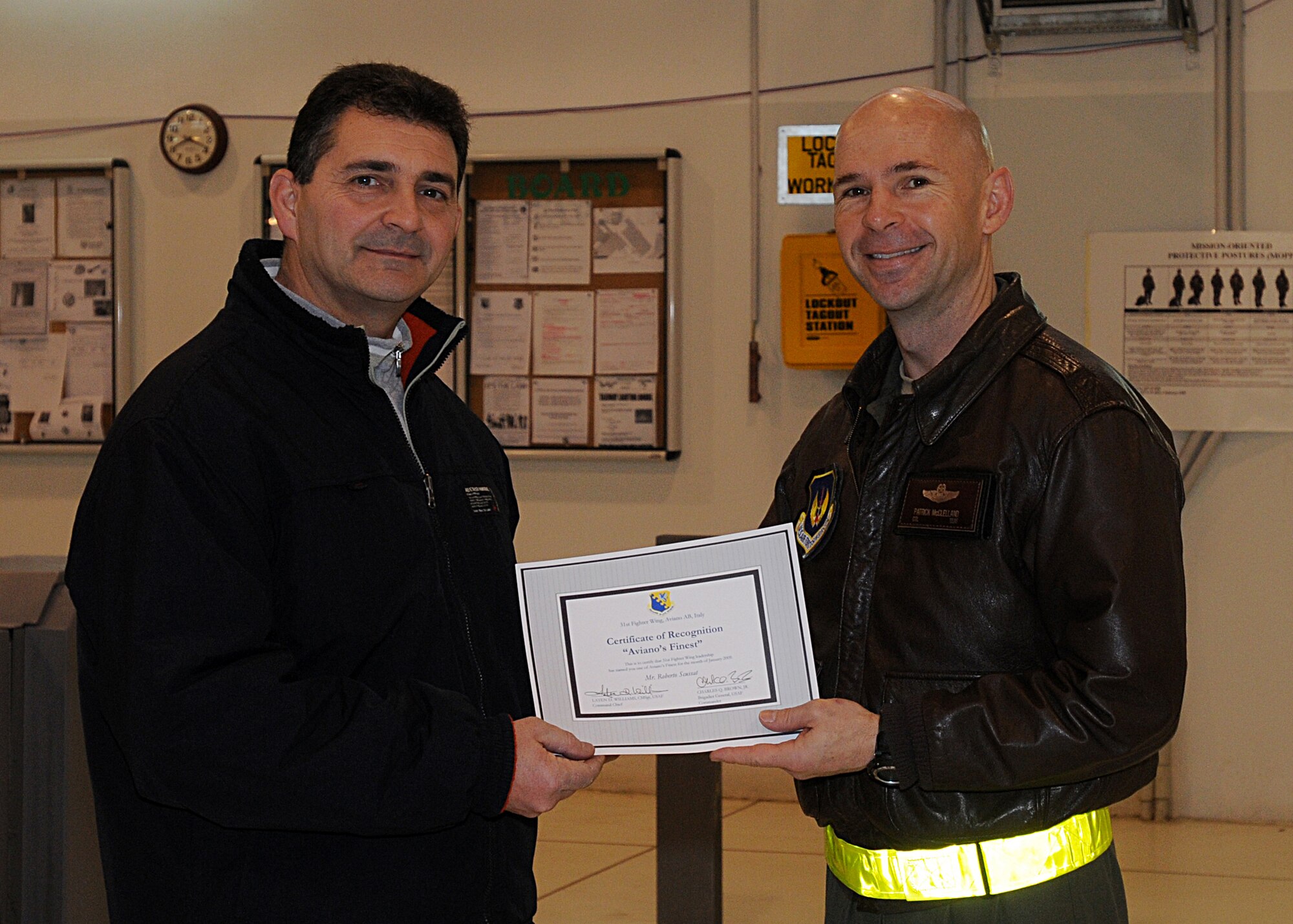 Colonel Patrick McClelland, 31st Fighter Wing vice commander, congratulates Roberto Scussat, 31st Maintenance Squadron, on his selection as one of Aviano's Finest.  (U.S. Air Force photo/Senior Airman Tabitha M. Mans)