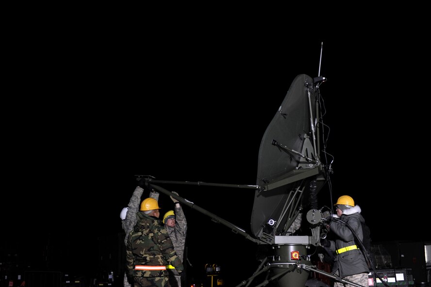 U.S. Air Force military members from the 1st Combat Communications Squadron, Ramstein Air Base, Germany, set up a communications satellite at Flugplatz Bitburg, Germany, Jan. 27, 2010, in preparation of Ramstein's operational readiness inspection in September. The units are setting up bare-base operations as part of the dual-wing operational readiness exercise with the 86th Airlift Wing. This is the second of five operational readiness exercises. (U.S. Air Force photo by Staff Sgt. Sarayuth Pinthong)