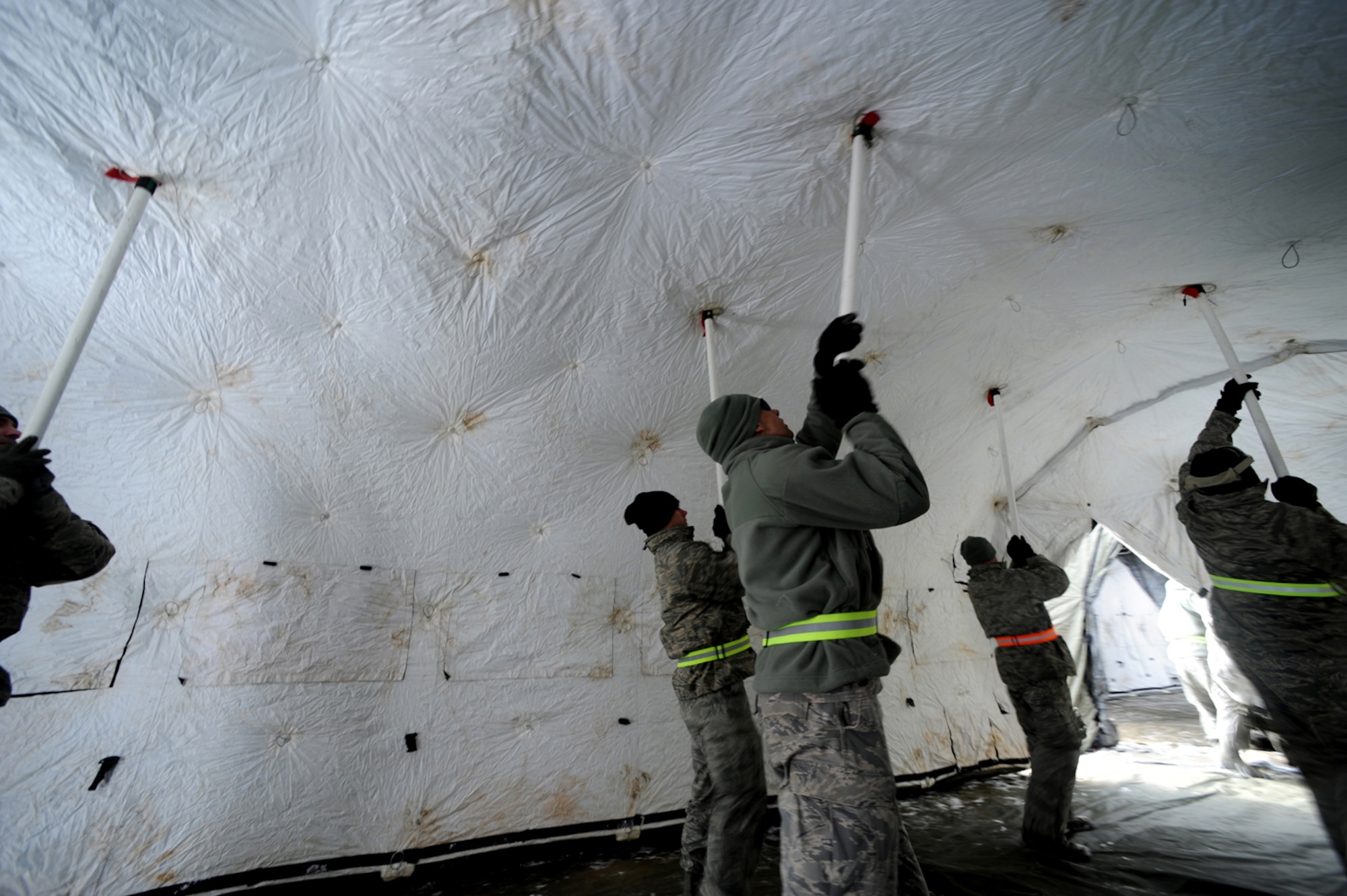 U.S. Air Force military members from the 435th Air Ground Operations Wing, Ramstein Air Base, Germany, construct tents at Flugplatz Bitburg, Germany, Jan. 27, 2010, in preparation of Ramstein's operational readiness inspection in September. The units are setting up bare-base operations as part of the dual-wing operational readiness exercise with the 86th Airlift Wing. This is the second of five operational readiness exercises. (U.S. Air Force photo by Staff Sgt. Sarayuth Pinthong)