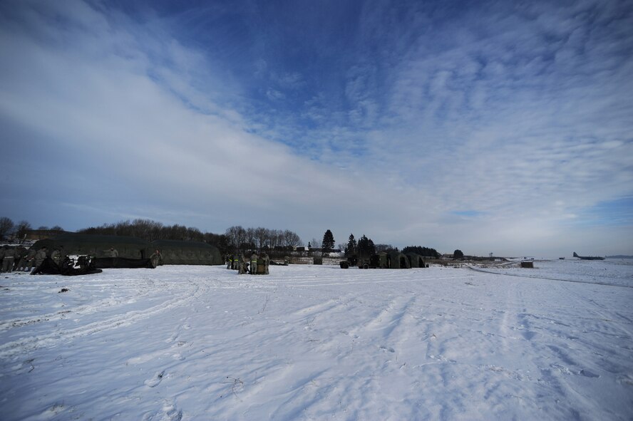U.S. Air Force military members from the 435th Air Ground Operations Wing, Ramstein Air Base, Germany, construct tents at Flugplatz Bitburg, Germany, Jan. 27, 2010, in preparation of Ramstein's operational readiness inspection in September. The units are setting up bare-base operations as part of the dual-wing operational readiness exercise with the 86th Airlift Wing. This is the second of five operational readiness exercises. (U.S. Air Force photo by Staff Sgt. Sarayuth Pinthong)
