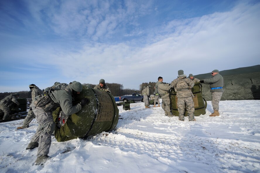 U.S. Air Force military members from the 435th Air Ground Operations Wing, Ramstein Air Base, Germany, construct tents at Flugplatz Bitburg, Germany, Jan. 27, 2010, in preparation of Ramstein's operational readiness inspection in September. The units are setting up bare-base operations as part of the dual-wing operational readiness exercise with the 86th Airlift Wing. This is the second of five operational readiness exercises. (U.S. Air Force photo by Staff Sgt. Sarayuth Pinthong)