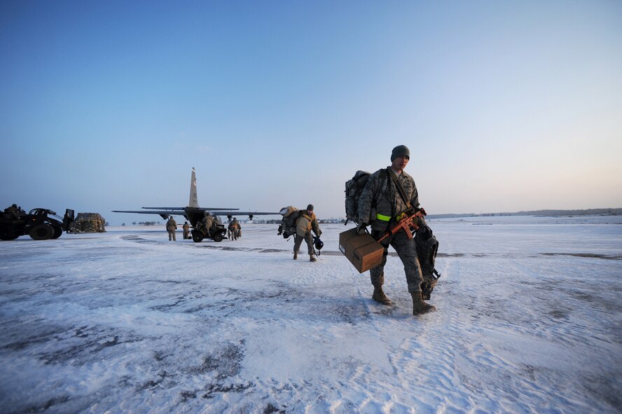 U.S. Air Force Tech. Sgt. Randal Komaki, 435th Contingency Response Group, Ramstein Air Base, Germany, gathers his gear after arriving at Flugplatz Bitburg, Germany, Jan. 26, 2010, in preparation of Ramstein's operational readiness inspection in September. The units are setting up bare-base operations as part of the dual-wing operational readiness exercise with the 86th Airlift Wing. This is the second of five operational readiness exercises. (U.S. Air Force photo by Staff Sgt. Sarayuth Pinthong)