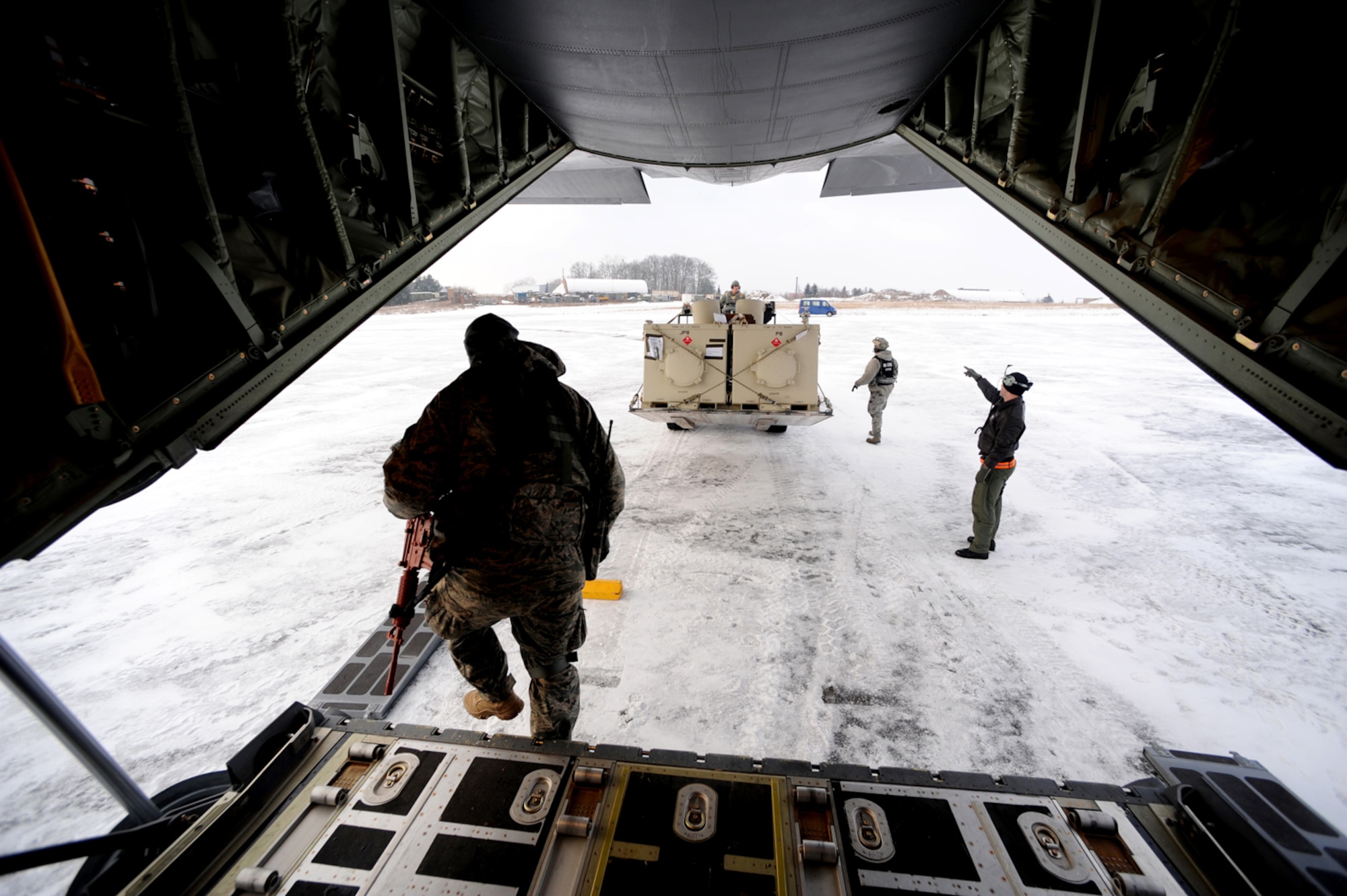 U.S. Air Force members off load cargo from a C-130 Hercules from Ramstein Air Base, Germany, after arriving at Flugplatz Bitburg, Germany, Jan. 26, 2010, in preparation of Ramstein's operational readiness inspection in September. The units are setting up bare-base operations as part of the dual-wing operational readiness exercise with the 86th Airlift Wing. This is the second of five operational readiness exercises. (U.S. Air Force photo by Staff Sgt. Sarayuth Pinthong)