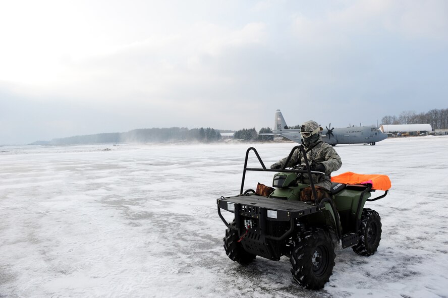 U.S. Air Force Master Sgt. Thomas Franz, 435th Air Mobility Squadron, contingency airfield manager, Ramstein Air Base, Germany, marshals  a C-130 Hercules carrying military members and cargo from Ramstein Air Base down a taxi-way at Flugplatz Bitburg, Germany, Jan. 26, 2010, in preparation of Ramstein's operational readiness inspection in September. The units are setting up bare-base operations as part of the dual-wing operational readiness exercise with the 86th Airlift Wing. This is the second of five operational readiness exercises. (U.S. Air Force photo by Staff Sgt. Sarayuth Pinthong)