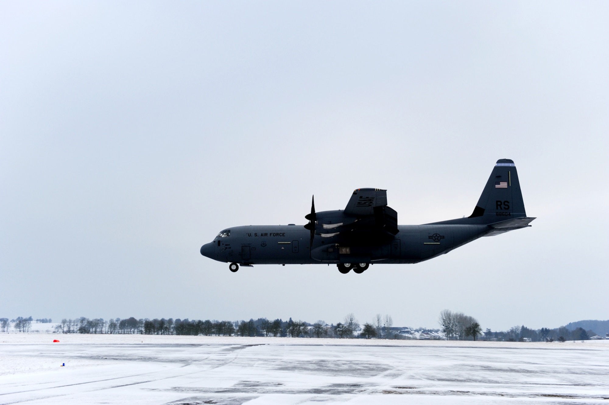 A U.S. Air Force C-130 Hercules carrying military members and cargo from Ramstein Air Base, Germany, prepares to land at Flugplatz Bitburg, Germany, Jan. 26, 2010, in preparation of Ramstein's operational readiness inspection in September. The units are setting up bare-base operations as part of the dual-wing operational readiness exercise with the 86th Airlift Wing. This is the second of five operational readiness exercises. (U.S. Air Force photo by Staff Sgt. Sarayuth Pinthong)