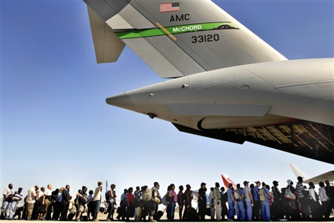 Haitian evacuees wait to board a U.S. Air Force C-17 Globemaster III aircraft at the Toussaint Louverture International Airport in Port-au-Prince, Haiti, Jan. 28, 2010. More than 100 Haitians were evacuated to a transition center in Orlando, Fla. U.S. Defense Department and the U.S. Agency for International Development are conducting the operation to provide aid and relief to Haitian citizens.