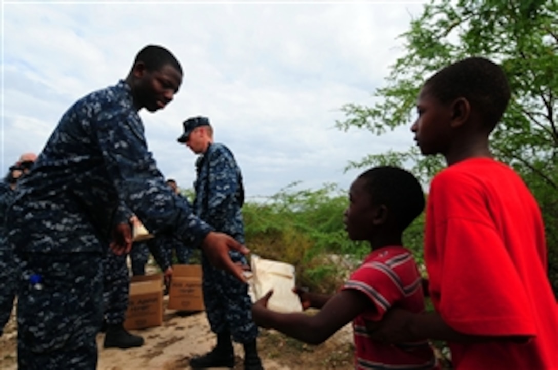 U.S. Navy sailors assigned to the guided-missile cruiser USS Bunker Hill (CG 52) distribute food from the non-profit organization Kids Against Hunger to residents of La Gonave, Haiti, on Jan. 26, 2010.  The Bunker Hill, the aircraft carrier USS Carl Vinson (CVN 70) and Carrier Air Wing 17 are conducting humanitarian and disaster relief operations in the island nation as part of Operation Unified Response.  