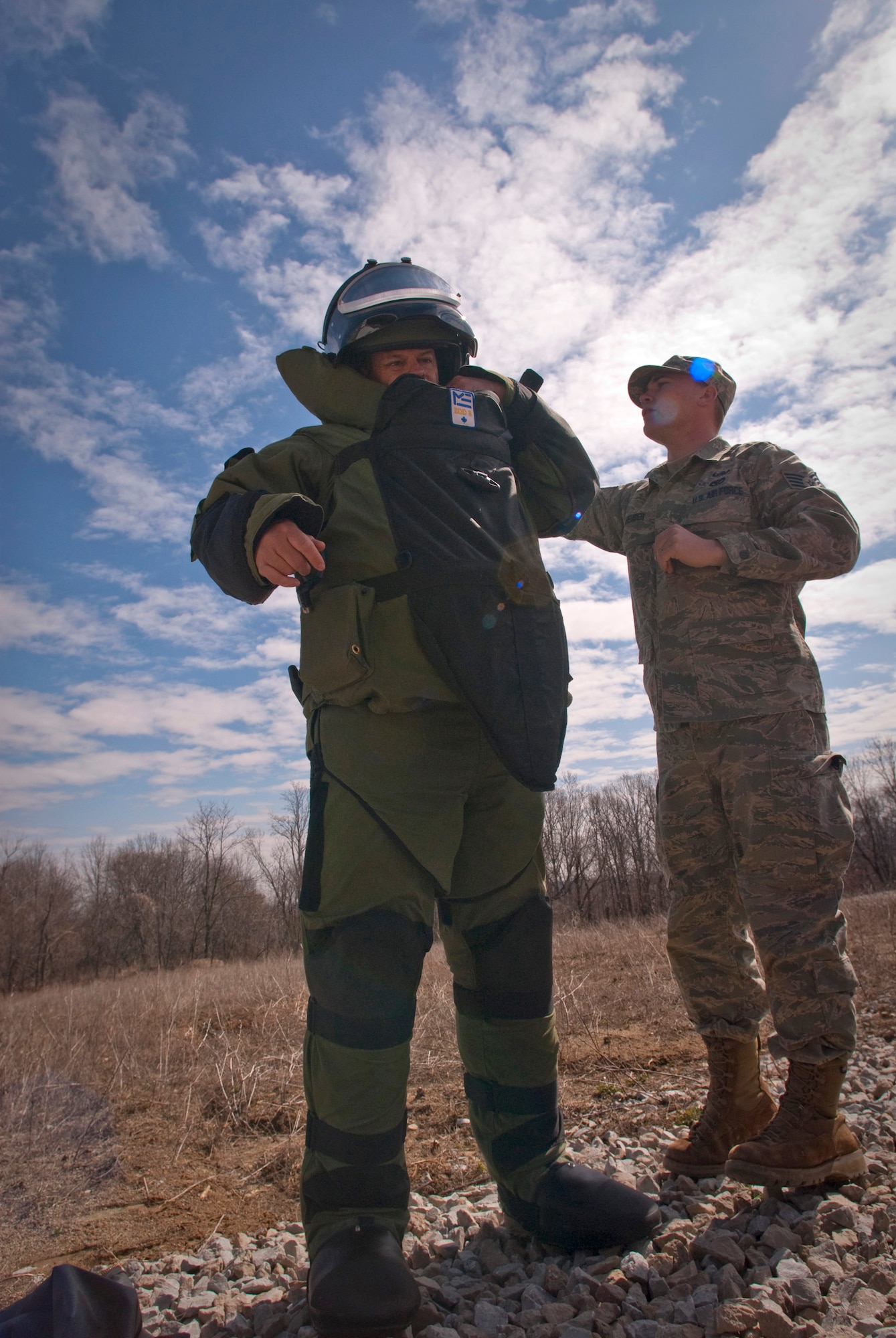 Staff Sgt. Matthew ?Mouse? Meuser helps fellow explosive ordnance disposal technician Tech. Sgt. Lowery Woods adjust his EOD 8 bomb suit before proceeding to x-ray a simulated pipe bomb during a training evolution at Camp Atterbury, Ind.  Kentucky Air National Guard Sergeants Meuser and Woods were on a training evolution after clearing the Indiana National Guard?s range of expended ordnance. (U.S. Air Force photo/Tech. Sgt. D. Clare)