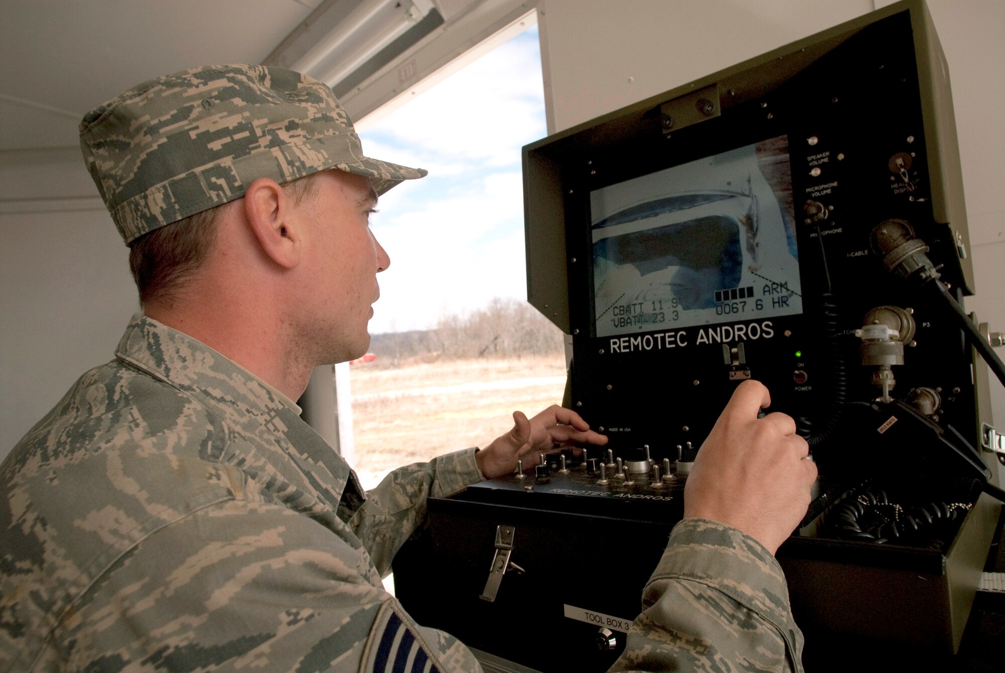 Staff Sgt. Matthew ?Mouse? Meuser, a Kentucky Air National Guard explosive ordnance disposal technician, controls the Remotec MK VI Andros robot as he checks a simulated suspicious vehicle during a training evolution at Camp Atterbury, Ind. In addition to clearing ordnance from an Indiana Air National Guard range on the base, Sergeant Meuser and his fellow EOD technicians were able to accomplish hands-on career-field training that would be impossible to complete at home station in Louisville, Ky. (U.S. Air Force photo/Tech. Sgt. D. Clare)