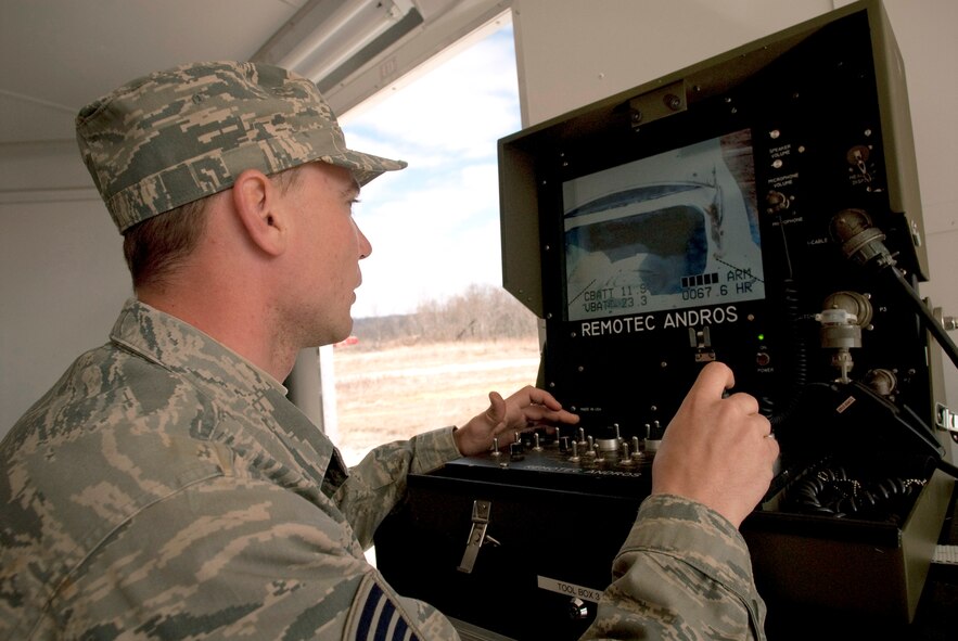 Staff Sgt. Matthew "Mouse" Meuser, a Kentucky Air National Guard explosive ordnance disposal technician, controls the Remotec MK VI Andros robot as he checks a simulated suspicious vehicle during a training evolution at Camp Atterbury, Ind. In addition to clearing ordnance from an Indiana Air National Guard range on the base, Sergeant Meuser and his fellow EOD technicians were able to accomplish hands-on career-field training that would be impossible to complete at home station in Louisville, Ky. (U.S. Air Force photo/Tech. Sgt. D. Clare)