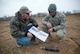 Sergeant Andy Squier, an Indiana State Police hazardous devices technician, and Senior Master Sgt. Lou Corner, Kentucky Air National Guard EOD superintendent, discuss an x-ray of a 90mm high explosive shell at the Camp Atterbury Air-to-Ground Gunnery Range, Camp Atterbury, Ind. The shell, which was turned in to the Indiana State Police and detonated by Kentucky and Indiana EOD techs, could have caused serious harm if it had exploded in a residential environment. (U.S. Air Force photo/Tech. Sgt. D. Clare)