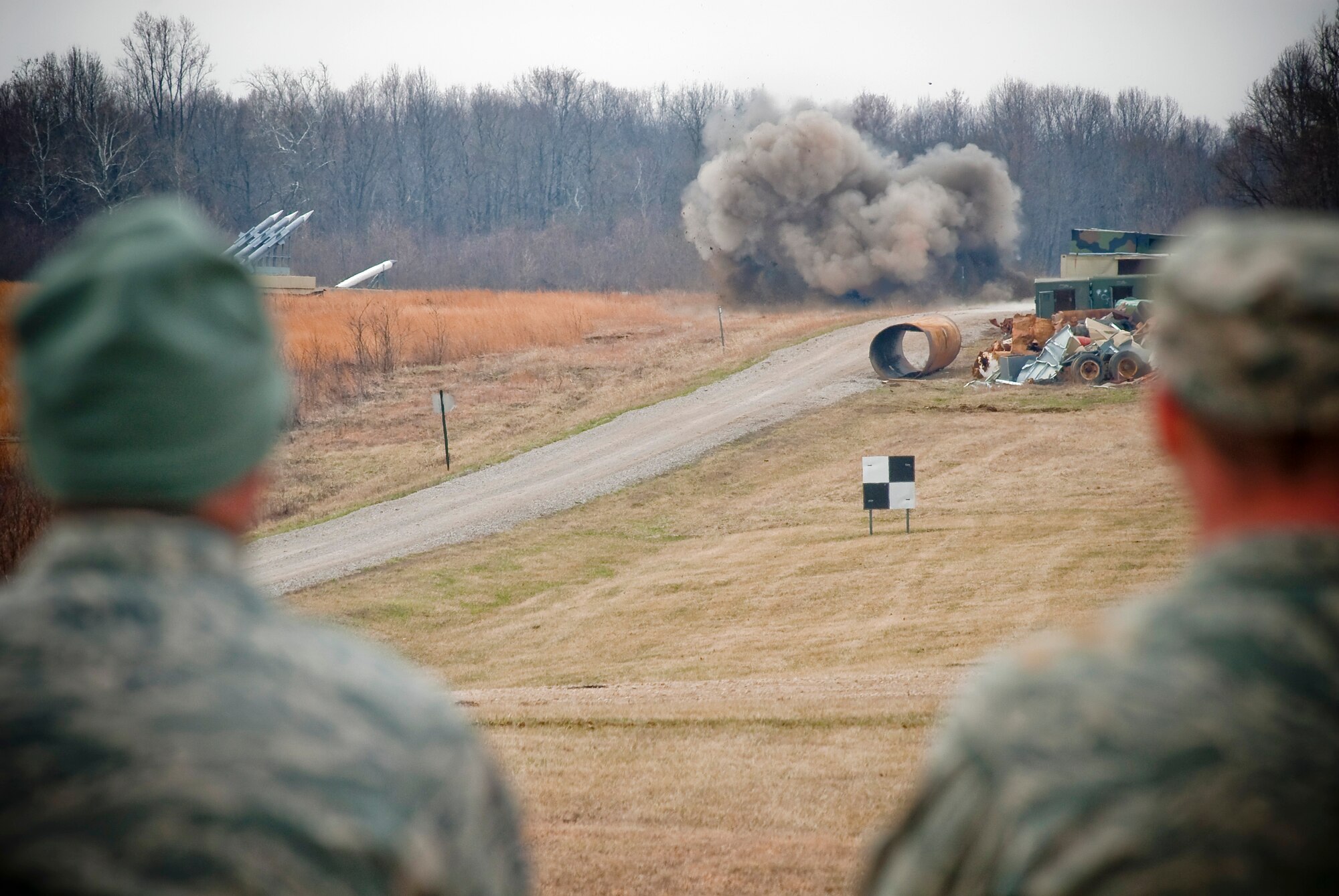 Explosive ordnance disposal technicians from the Kentucky Air National Guard watch a controlled detonation of ordnance at the Camp Atterbury Air-to-Ground Gunnery Range, Camp Atterbury, Ind. While the excitement of a detonation is rewarding for the Airmen, safety is their primary goal in combat, stateside missions and training evolutions.