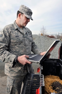 Senior Airman Ryan Locke, 316th Civil Engineer Squadron explosive ordnance disposal technician, uses a laptop computer to identify unexploded ordnance Jan. 20, 2010. Andrews EOD responds to any UXO calls for Joint Bases Andrews, Bolling AFB, and Anacostia Naval Air Station, D.C.. (U.S. Air Force photo by Airman 1st Class Perry Aston)