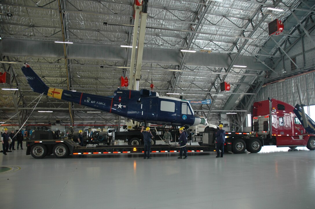 The 1st Helicopter Squadron's static display, previously located outside Hangar 1 on Joint Base Andrews, Md., is loaded by crane onto a flatbed truck Jan. 26, 2010. The UH-N1 Huey helicopter was transferred to the U.S. Army Aviation Museum at Fort Rucker, Ala. Once at the museum, the helicopter will be restored and repainted to the Army's Vietnam-era paint scheme. (U.S. Air Force photo by Bob Spiers)