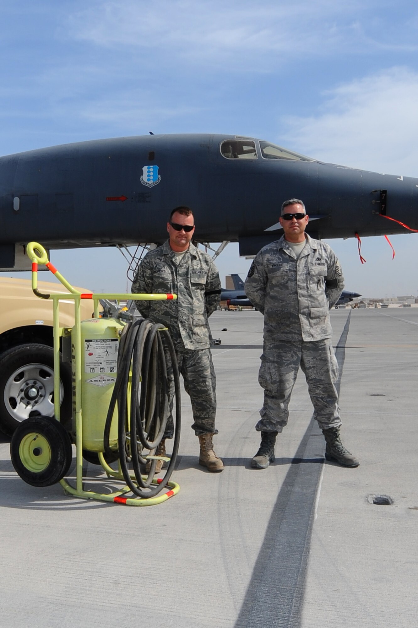 Master Sgts. Alan Andrews (left) and Michael Wingler (right), both 37th Aircraft Maintenance Unit production supervisors, stand in front of the B-1B Lancer that they saved alongside the rescue equipment at a non-disclosed Southwest Asia Jan. 23, 2010. Their actions ensured the safety of four aircrew members and prevented the possible destruction of a munitions-loaded aircraft at a non-disclosed Southwest Asia Jan. 28, 2010. (U.S. Air Force photo by Senior Airman Kasey Zickmund)