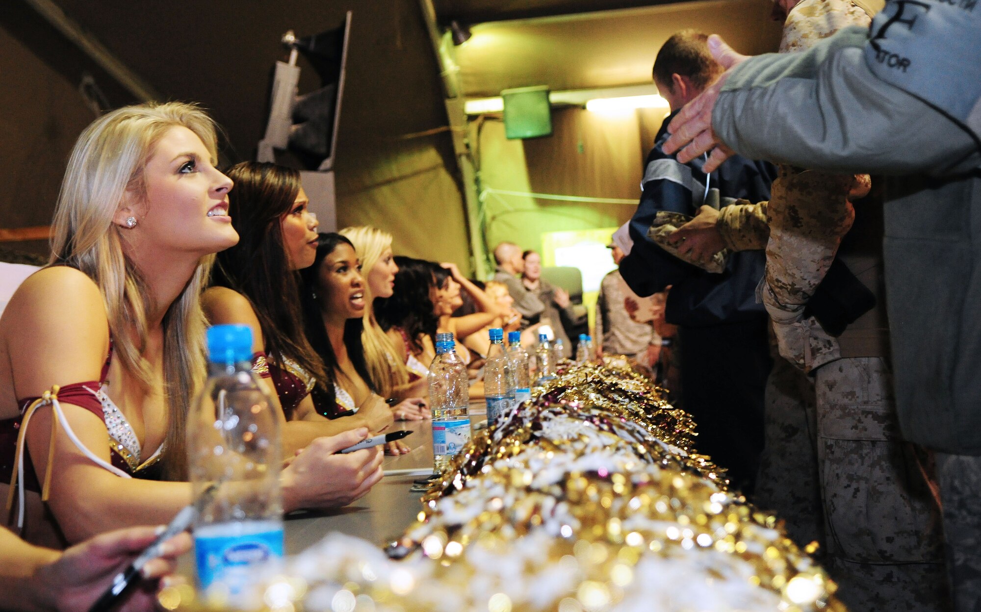 Washington Redskins cheerleaders sign autographs for Airmen, Soldiers, Sailors and Marines deployed or transiting through Transit Center at Manas, Kyrgyzstan, Jan. 28, 2010. (U.S. Air Force photo/Senior Airman Nichelle Anderson/Released)
