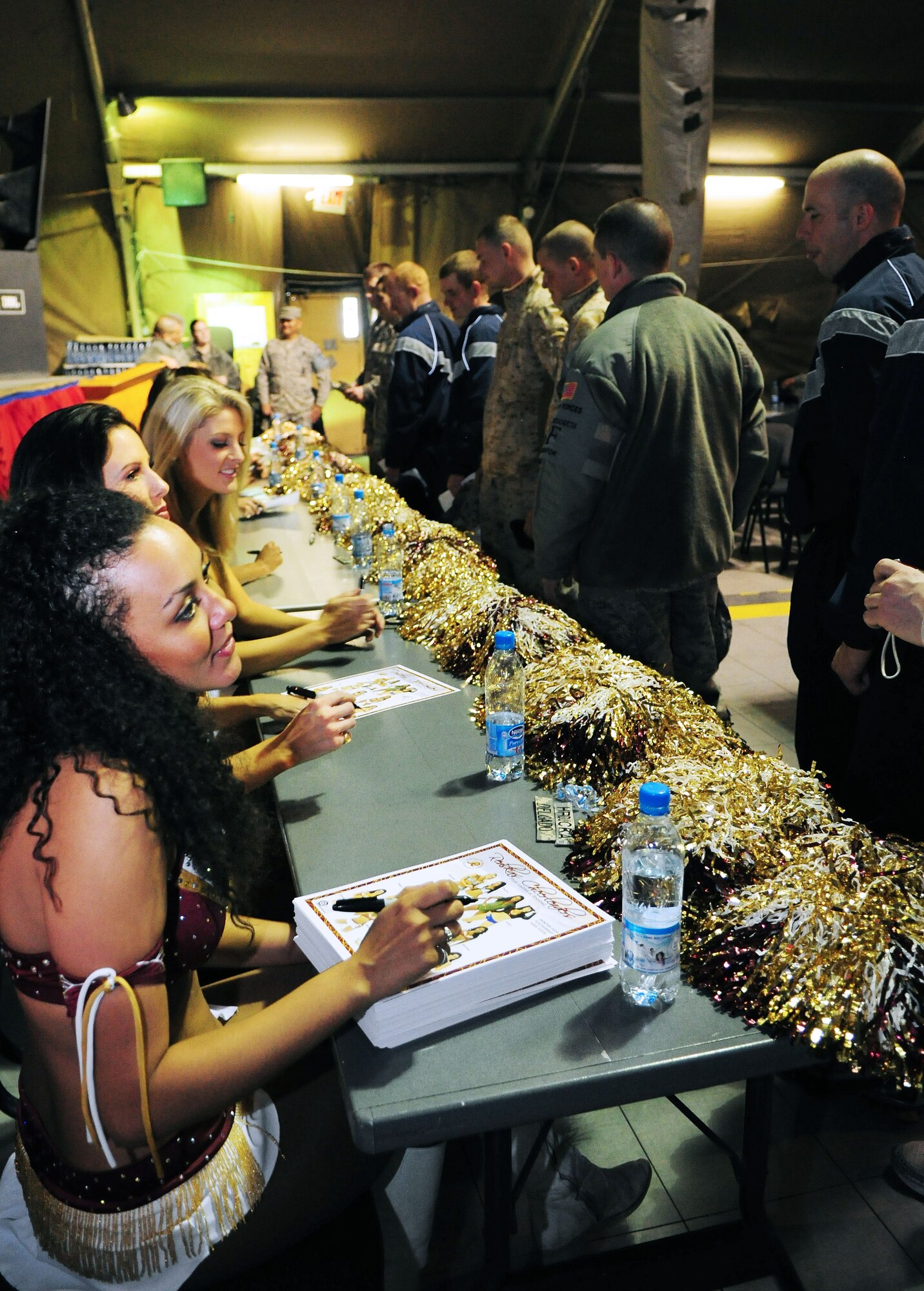 Washington Redskins cheerleaders sign autographs for Airmen, Soldiers, Sailors and Marines deployed or transiting through Transit Center at Manas, Kyrgyzstan, Jan. 28, 2010. (U.S. Air Force photo/Senior Airman Nichelle Anderson/Released)
