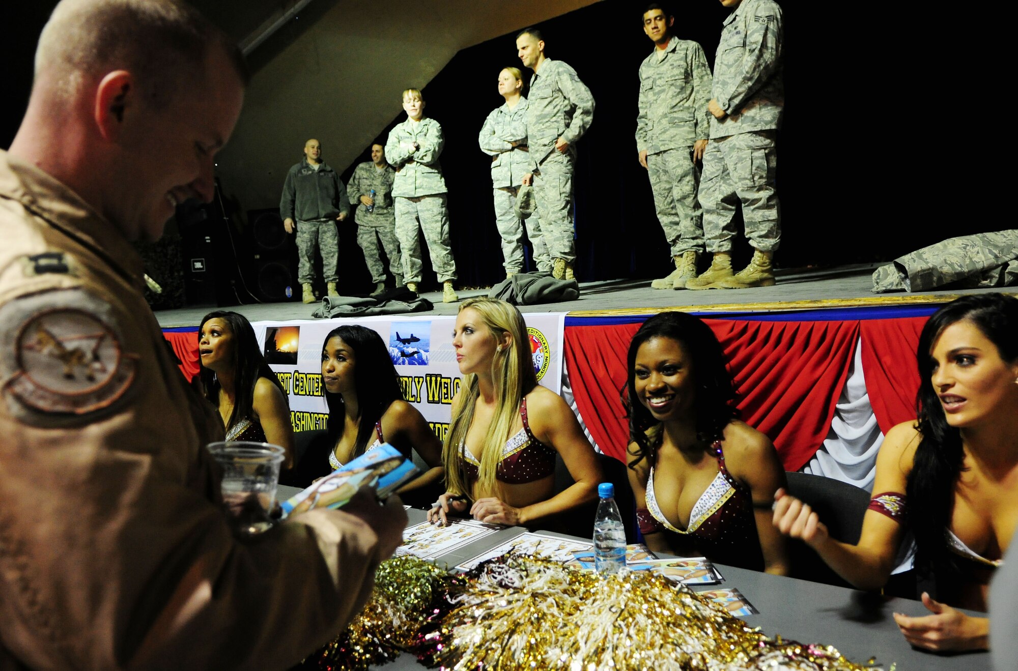 Washington Redskins cheerleaders sign autographs for Airmen, Soldiers, Sailors and Marines deployed or transiting through Transit Center at Manas, Kyrgyzstan, Jan. 28, 2010. (U.S. Air Force photo/Senior Airman Nichelle Anderson/Released)
