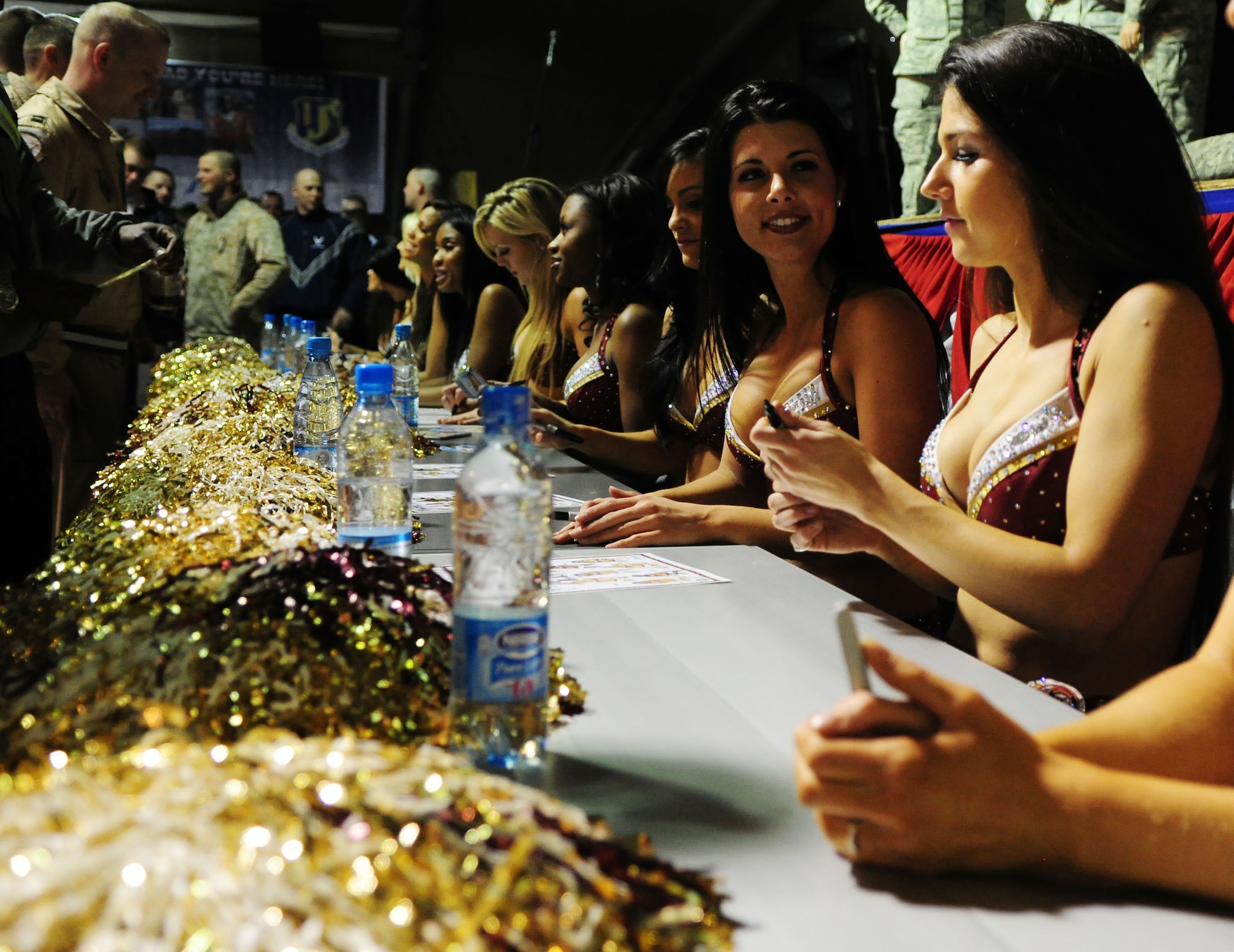 Washington Redskins cheerleaders sign autographs for Airmen, Soldiers, Sailors and Marines deployed or transiting through Transit Center at Manas, Kyrgyzstan, Jan. 28, 2010. (U.S. Air Force photo/Senior Airman Nichelle Anderson/Released)
