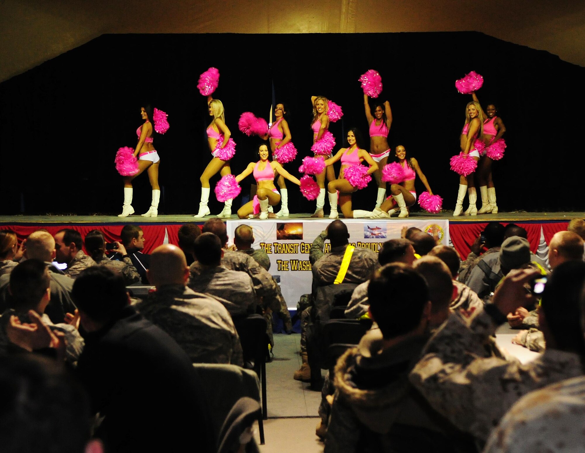 Washington Redskins cheerleaders perform for Airmen, Soldiers, Sailors and Marines deployed or transiting through Transit Center at Manas, Kyrgyzstan, Jan. 28, 2010. The Transit Center is their first stop in a two-week long tour performing for servicemembers deployed to Southwest Asia. (U.S. Air Force photo/Senior Airman Nichelle Anderson/Released)