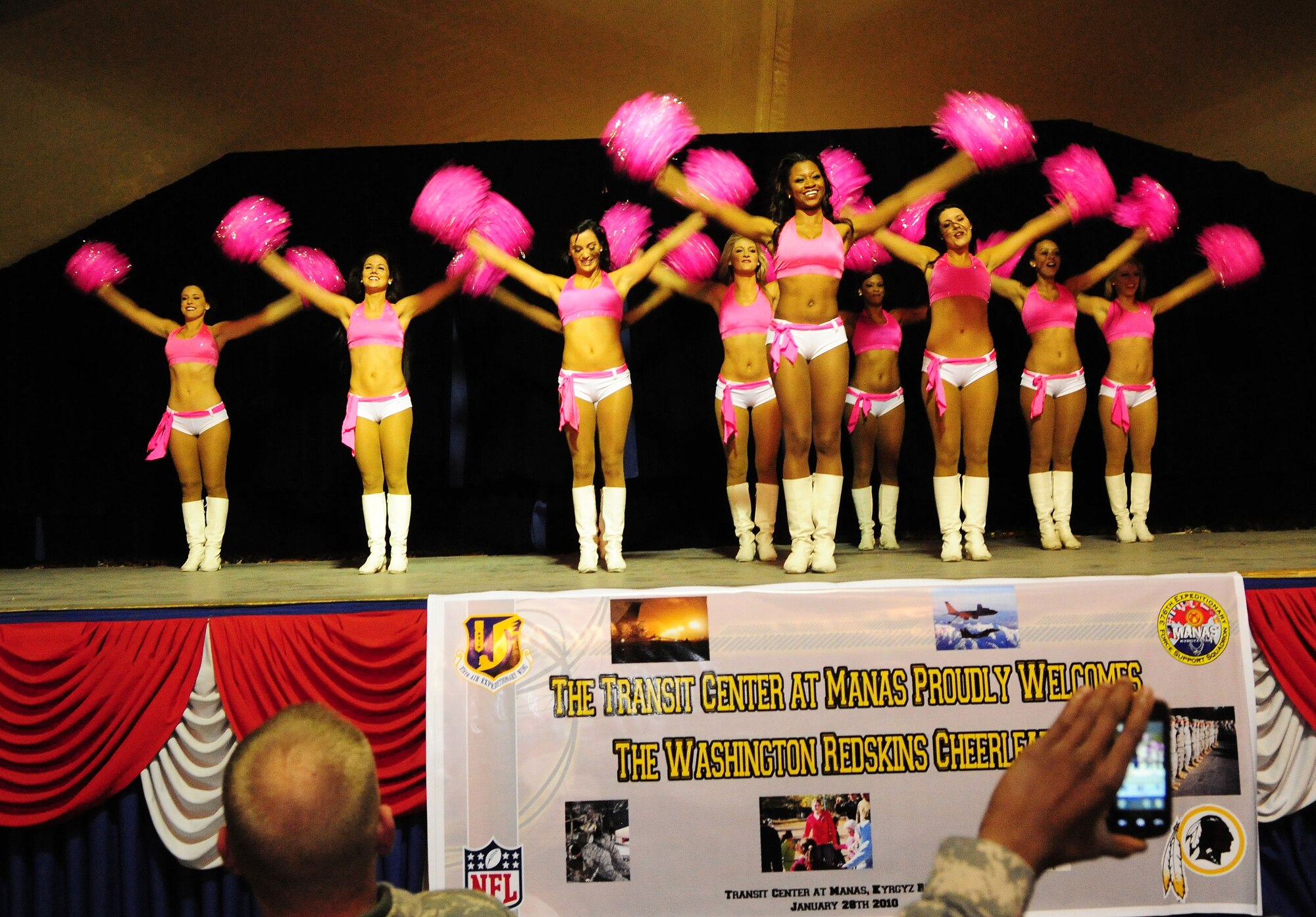 Washington Redskins cheerleaders perform for Airmen, Soldiers, Sailors and Marines deployed or transiting through Transit Center at Manas, Kyrgyzstan, Jan. 28, 2010. The Transit Center is their first stop in a two-week long tour performing for servicemembers deployed to Southwest Asia. (U.S. Air Force photo/Senior Airman Nichelle Anderson/Released)