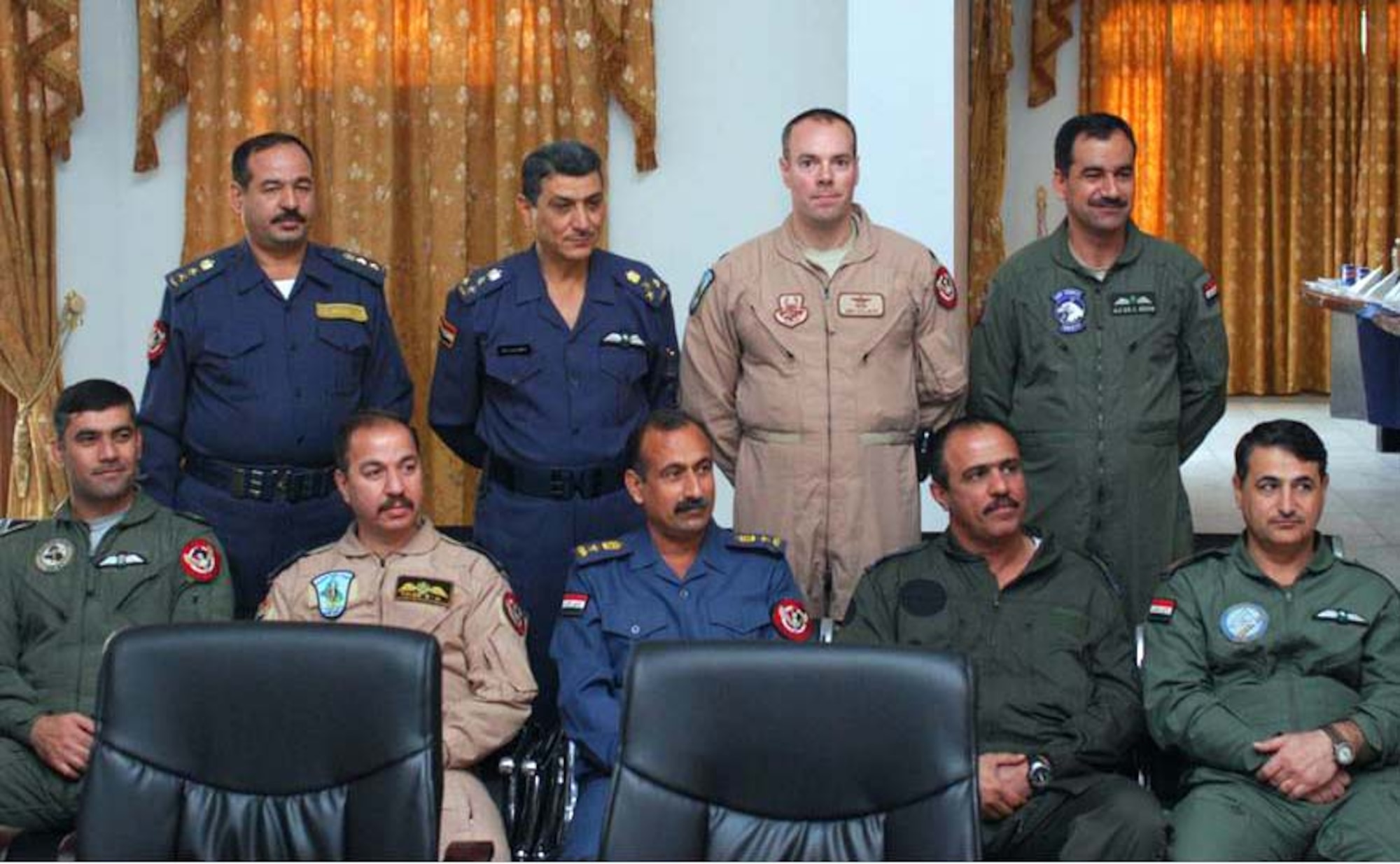 Iraqi safety officer's pose with Lt. Col. Andrew Sellberg, Safety Advisor and Instructor, during the advanced flight safety officers graduation Jan. 24, 2010. Stting in front row, from right to left, Col Khalid, Lt .Col. Muhammed, Lt. Col. Khalid, Maj Taleb, Maj Hussam. Back row, from right to left, Lt. Col. Ala'din, Lt. Col. Sellbeg,  Brig. Gen. Salh and Col Muhammed.