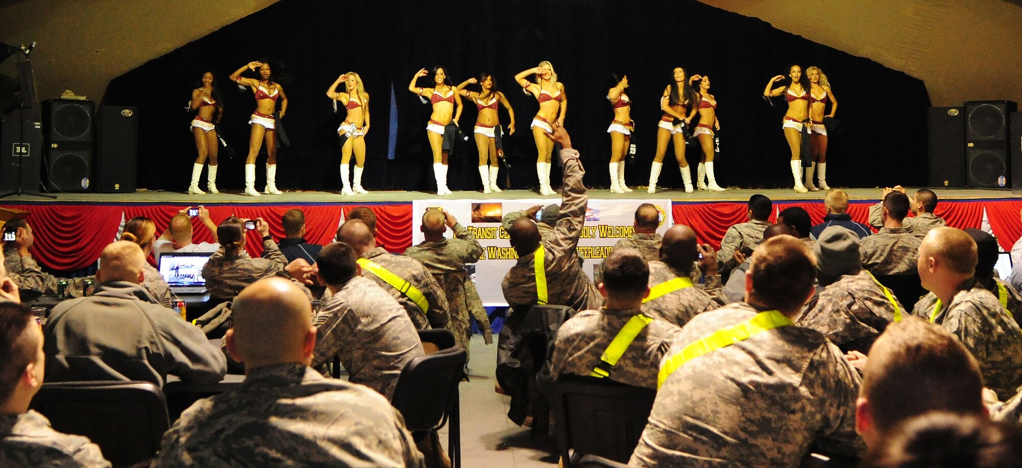 Washington Redskins cheerleaders perform for Airmen, Soldiers, Sailors and Marines deployed or transiting through Transit Center at Manas, Kyrgyzstan, Jan. 28, 2010. The Transit Center is their first stop in a two-week long tour performing for servicemembers deployed to Southwest Asia. (U.S. Air Force photo/Senior Airman Nichelle Anderson/Released)
