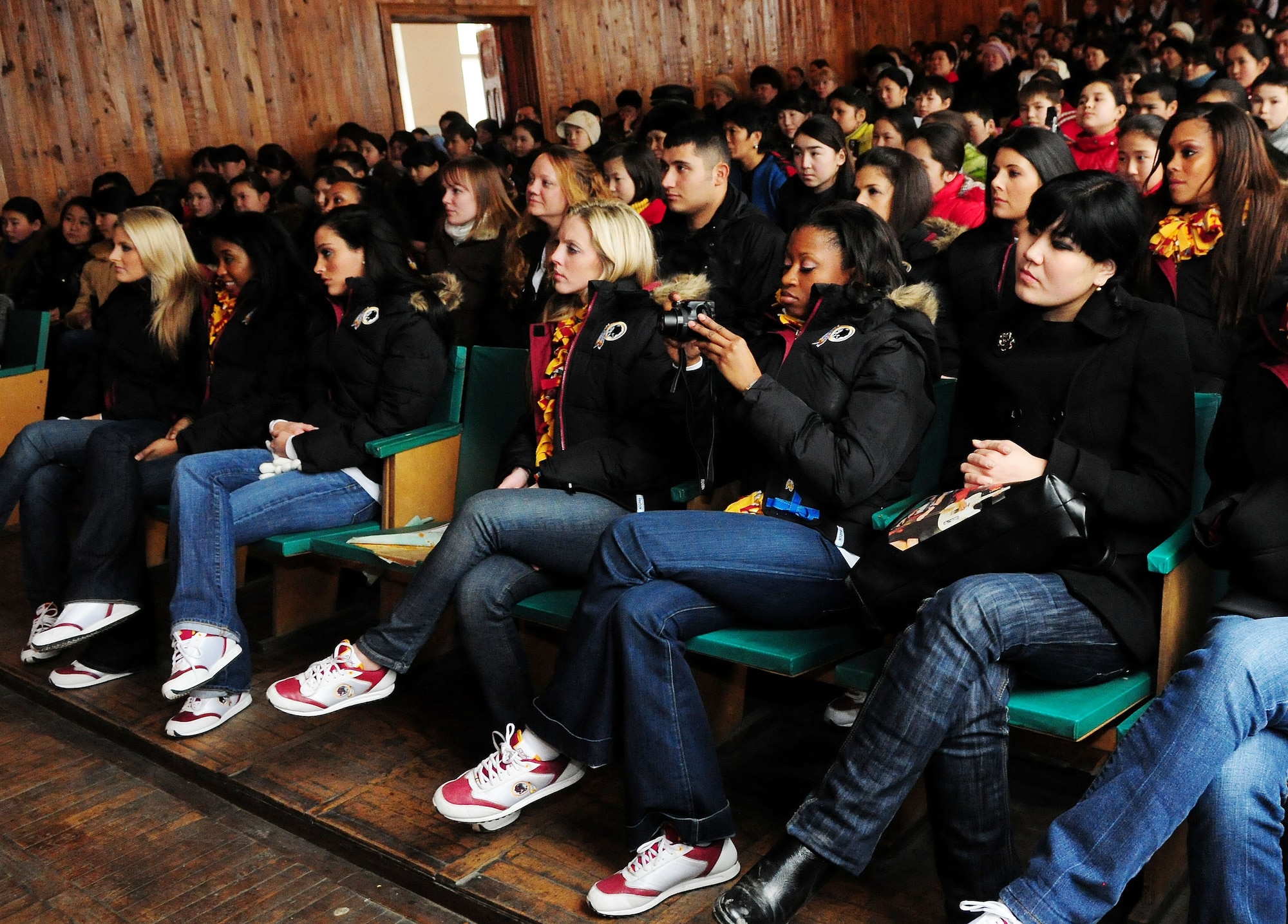 The Washington Redskins cheerleaders watch as students from the Abdraev Musical Boarding School play traditional Kyrgyz instruments in Bishkek, Kyrgyzstan, Jan. 27, 2010. The cheerleaders are on tour sponsored by the Armed Forces Entertainment. The Transit Center at Manas is their first stop in a two-week long tour where they will perform for Airmen, Soldiers, Sailors and Marines deployed overseas. (U.S. Air Force photo/Senior Airman Nichelle Anderson/Released)
