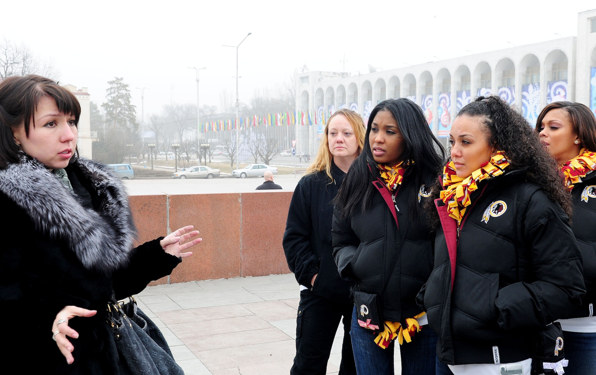 Senior Airman Maria Gates, 376th Air Expeditionary Wing translator and native of Kyrgyzstan, speaks of the history and culture of the land to the Washington Redskins cheerleaders on a tour of downtown Bishkek, Kyrgyzstan, Jan. 27, 2010. The cheerleaders are on tour sponsored by the Armed Forces Entertainment. The Transit Center at Manas is their first stop in a two-week long tour where they will perform for Airmen, Soldiers, Sailors and Marines deployed overseas. (U.S. Air Force photo/Senior Airman Nichelle Anderson/Released)