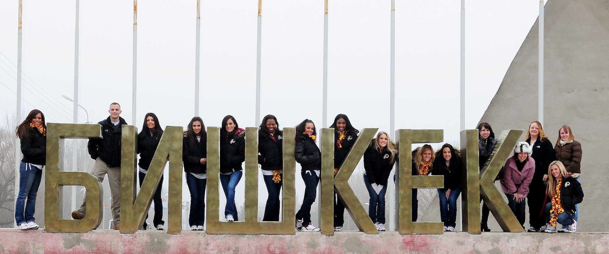 Washington Redskins cheerleaders, along with Airmen from the Transit Center at Manas, pose for a group photo with a sign that reads "Bishkek" during a cultural tour of the city in Kyrgyzstan. The cheerleaders are on tour sponsored by the Armed Forces Entertainment. The Transit Center at Manas is their first stop in a two-week long tour where they will perform for Airmen, Soldiers, Sailors and Marines deployed overseas. (U.S. Air Force photo/Senior Airman Nichelle Anderson/Released)