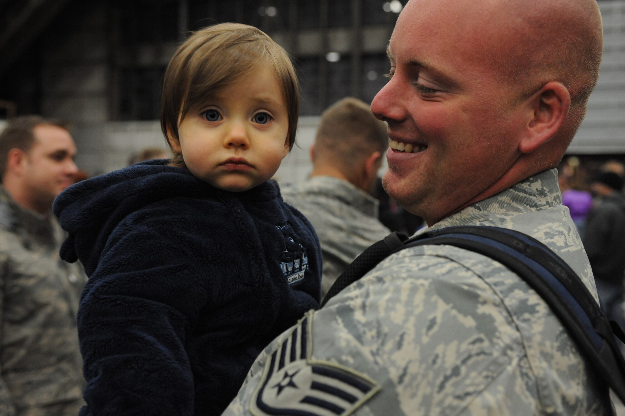 ELLSWORTH AIR FORCE BASE, S.D.-- Staff Sgt. Ryan Walker, 28th Aircraft Maintenance Squadron crew chief, holds his child, Camden after returning from a deployment from Southwest Asia, Jan. 30. Approximately 300 Airmen serving in various roles, deployed to support Operations Iraqi and Enduring Freedom. (U.S. Air Force photo/Airman 1st Class Corey Hook)