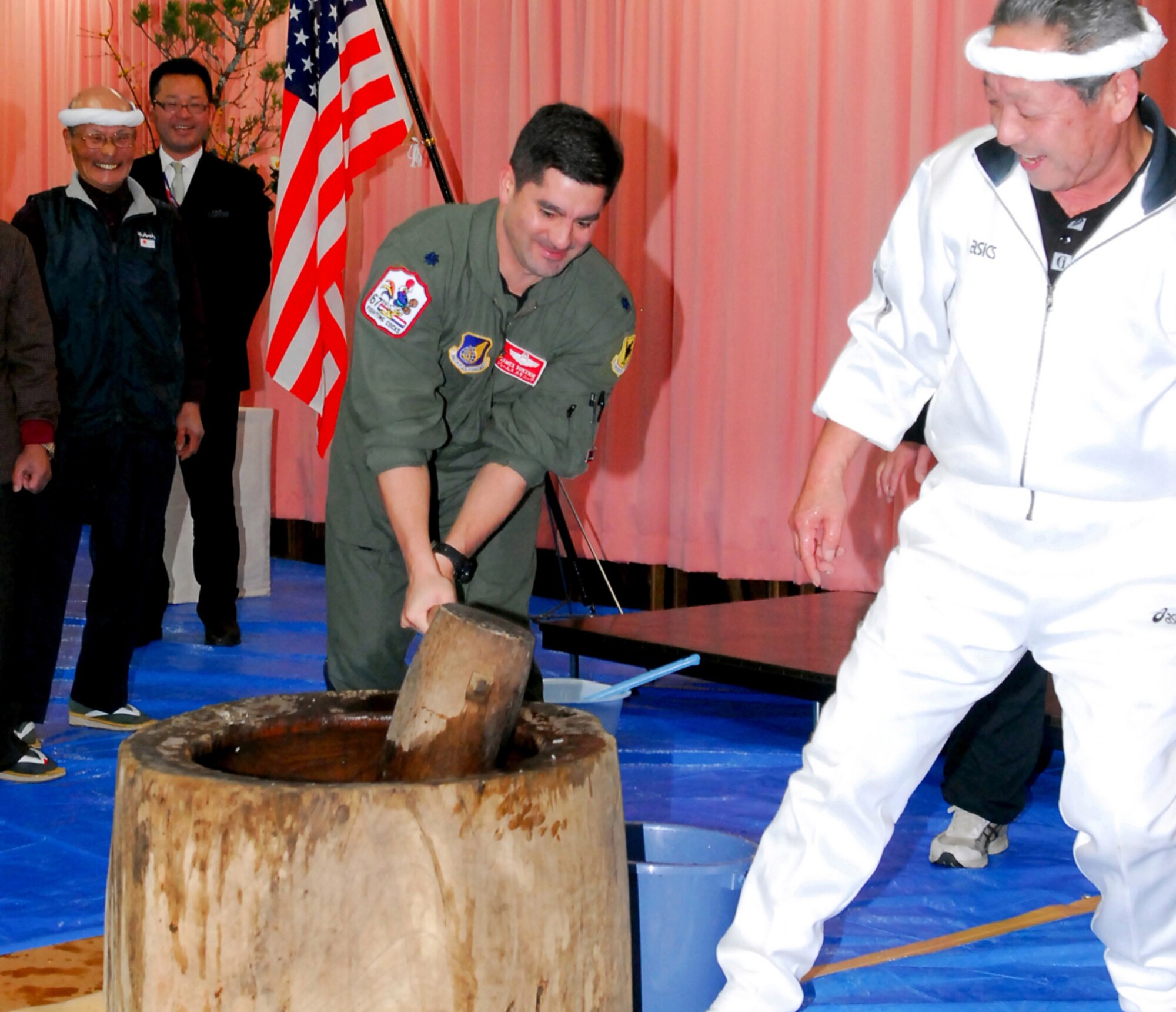 Lt. Col. James Sukenik, 67th Fighter Squadron director of operations, slams the "kine" during the Japanese mochitsuki festival. Mochi is a traditional food for the Japanese New Year and is commonly sold and eaten during that time. Airmen from Hyakuri Air Base and members of the local community invited the U.S. Air Force Airmen to participate in the special event. (U.S. Air Force / 1st Lt. Bryan Bouchard)