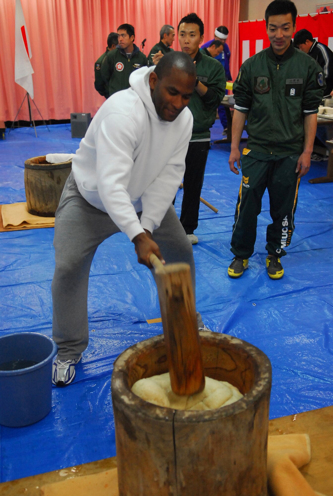 Tech. Sgt. Moises Martinez throws down the kine during Mochitsuki at Hyakuri Air Base Jan. 30. The annual festival coincides with the Japanese New Year and involves making mochi-rice into a jelly-like paste. Airmen from Hyakuri Air Base and members of the local community invited the U.S. Air Force Airmen to participate in the event. (U.S. Air Force / 1st Lt. Bryan Bouchard)