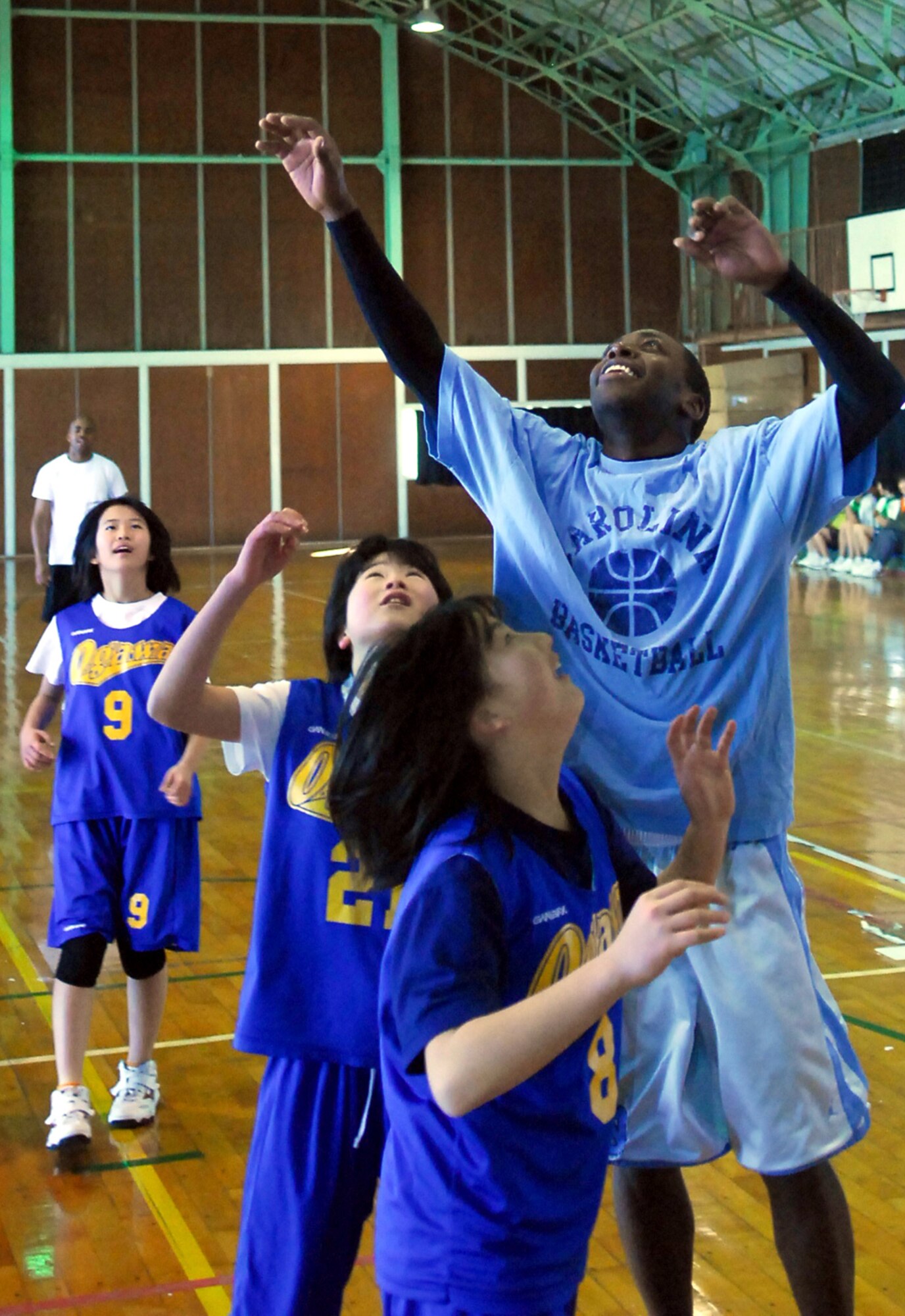 Staff Sgt. Albert Rhone from the 67th Aircraft Maintenance Unit, outstretches some 12-year-old basketball players from Iberaki Prefecture during a basketball game Jan. 30. Basketball and soccer were on the agenda during a sports day held in honor of the visiting Airmen from Kadena Air Base. About 100 Airmen and 6 F-15Cs are currently operating from Hyakuri Air Base about 70 miles north of Tokyo as part of an aviation training relocation. The Kadena Airmen will be there for one week. (U.S. Air Force photo / 1st Lt. Bryan Bouchard)