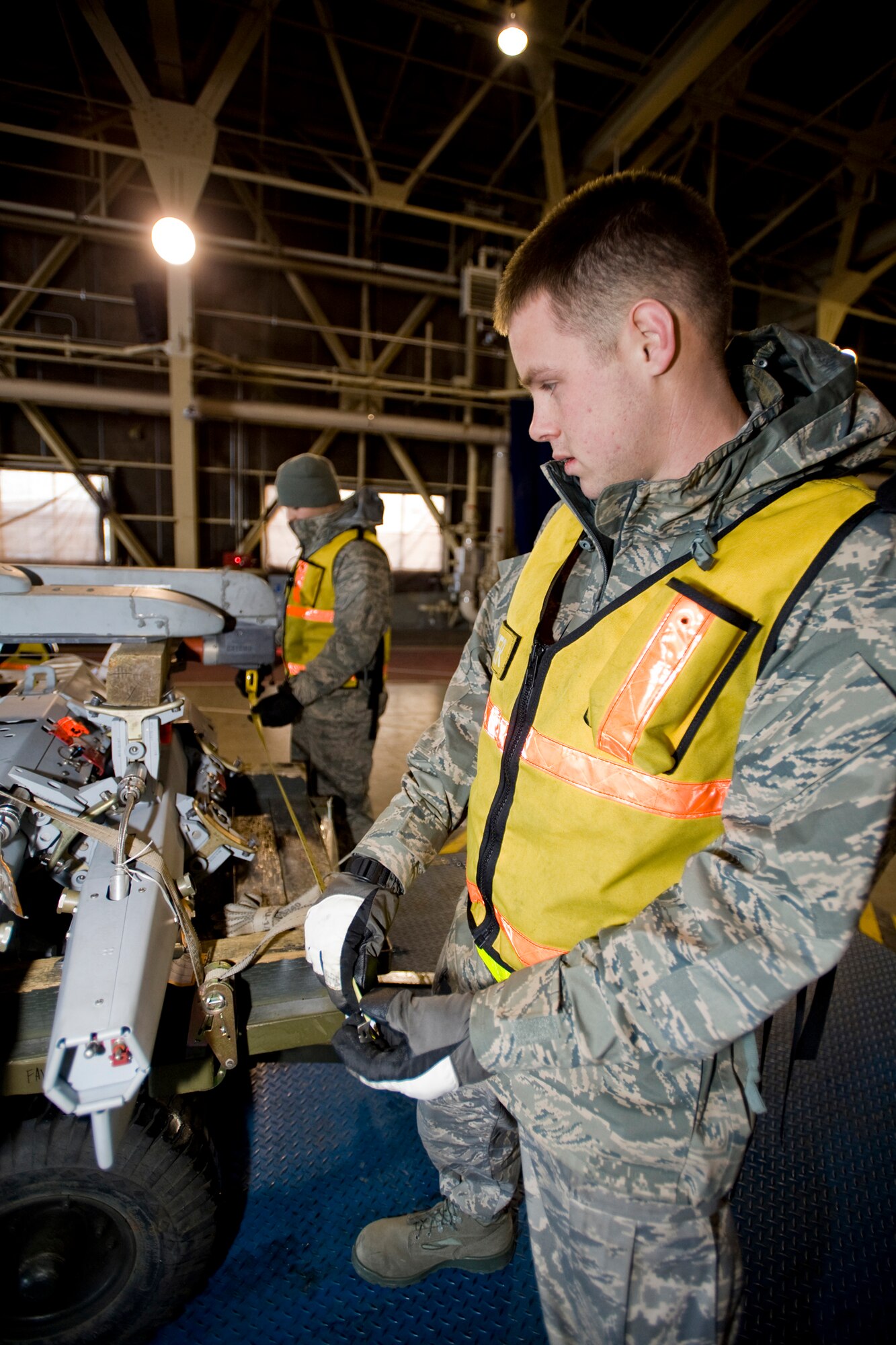 MISAWA AIR BASE, Japan -- Airmen 1st Class Matt Lombard and Christopher Caldwell measure for center balance on a weapons-pylon trailer during an operational readiness exercise Jan. 30 in Hangar 949. Airmen Lombard and Caldwell are assigned to the 35th Maintenance Squadron. (U.S. Air Force photo/Senior Airman Jamal D. Sutter)