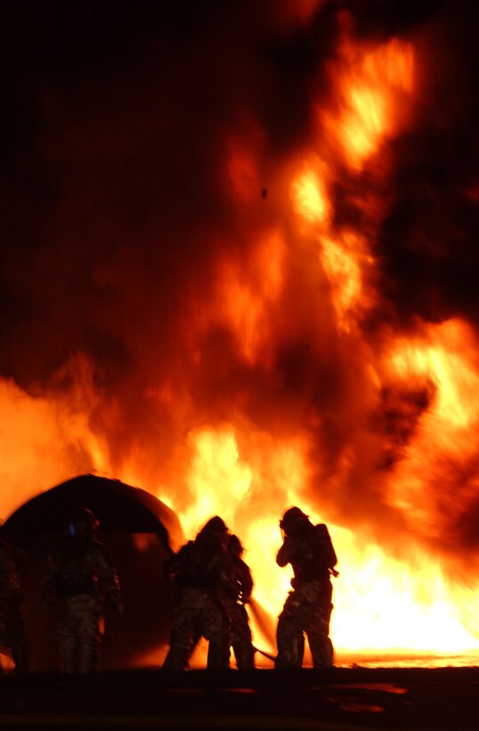 Marines from Aircraft Rescue and Fire Fighting battle a fuel fire during training Jan. 29. The Marines completed the training to hone their fire fighting skills in case of an emergeny on the Marine Corps Air Station Miramar flight line.