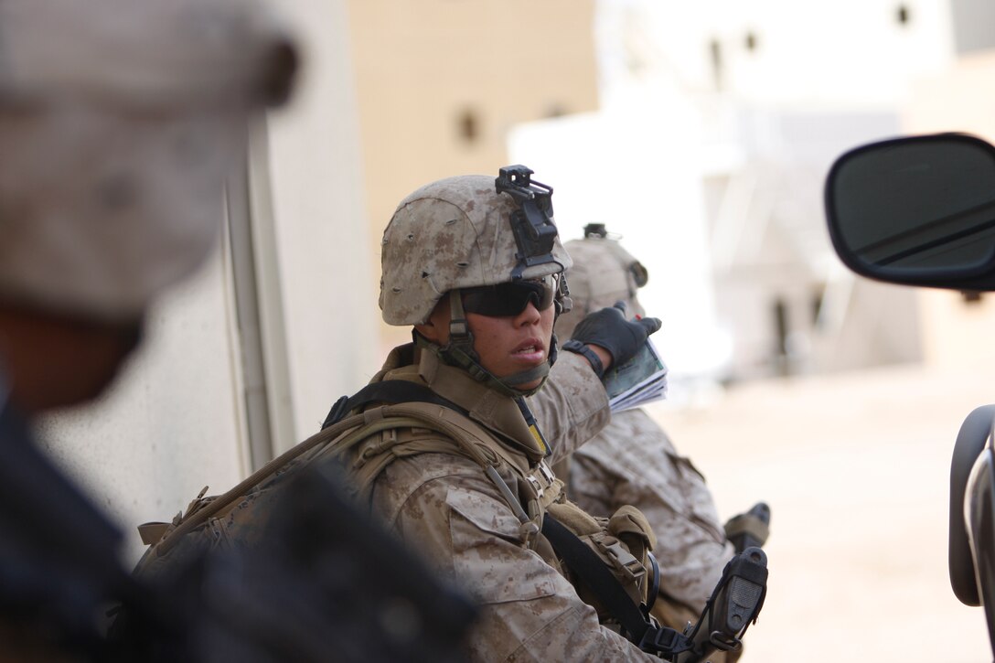 Lance Cpl. Mengqi Xu, a team leader with Company K, 3rd Battalion, 1st Marine Regiment, from Marine Corps Base Camp Pendleton, Calif., points out positions of enemy combatants Jan. 31 at Combat Center Range 220. The battalion is slated to deploy in support of Operation Enduring Freedom this spring.