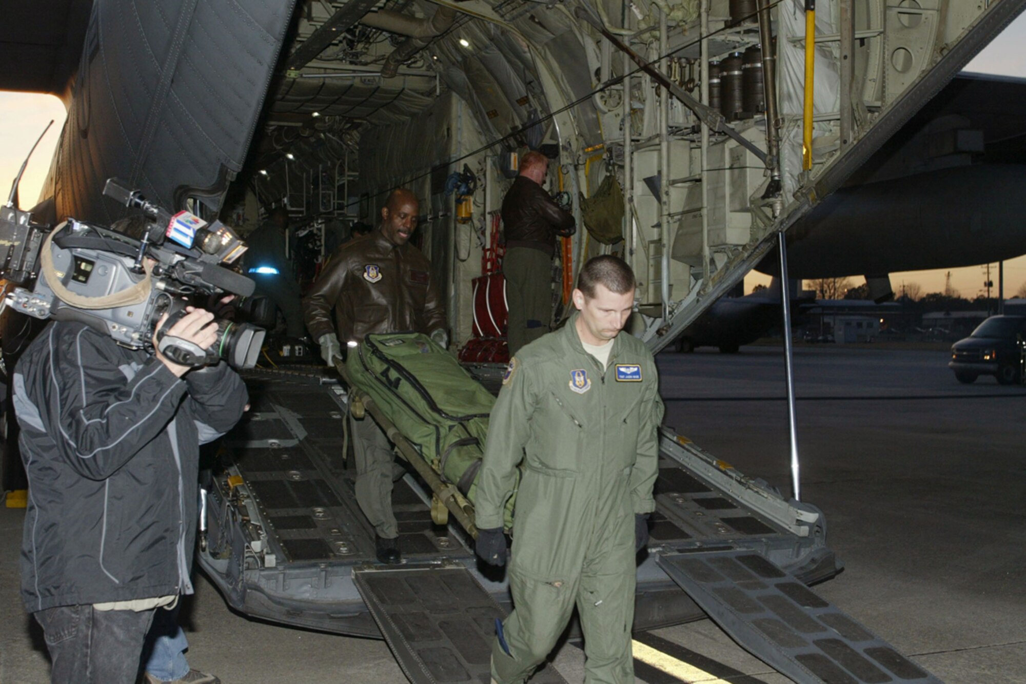94th Aeromedical Evacuation Squadron members Tech. Sgt. Jason L. Wade and Master Sgt. Jon Wallace, medical technicians, off load medical equipment Jan. 31 they used to provide critical assistance to Haitians. The crew returned from a two-week deployment in support of Operation Unified Response. (U.S. Air Force photo/Don Peek)