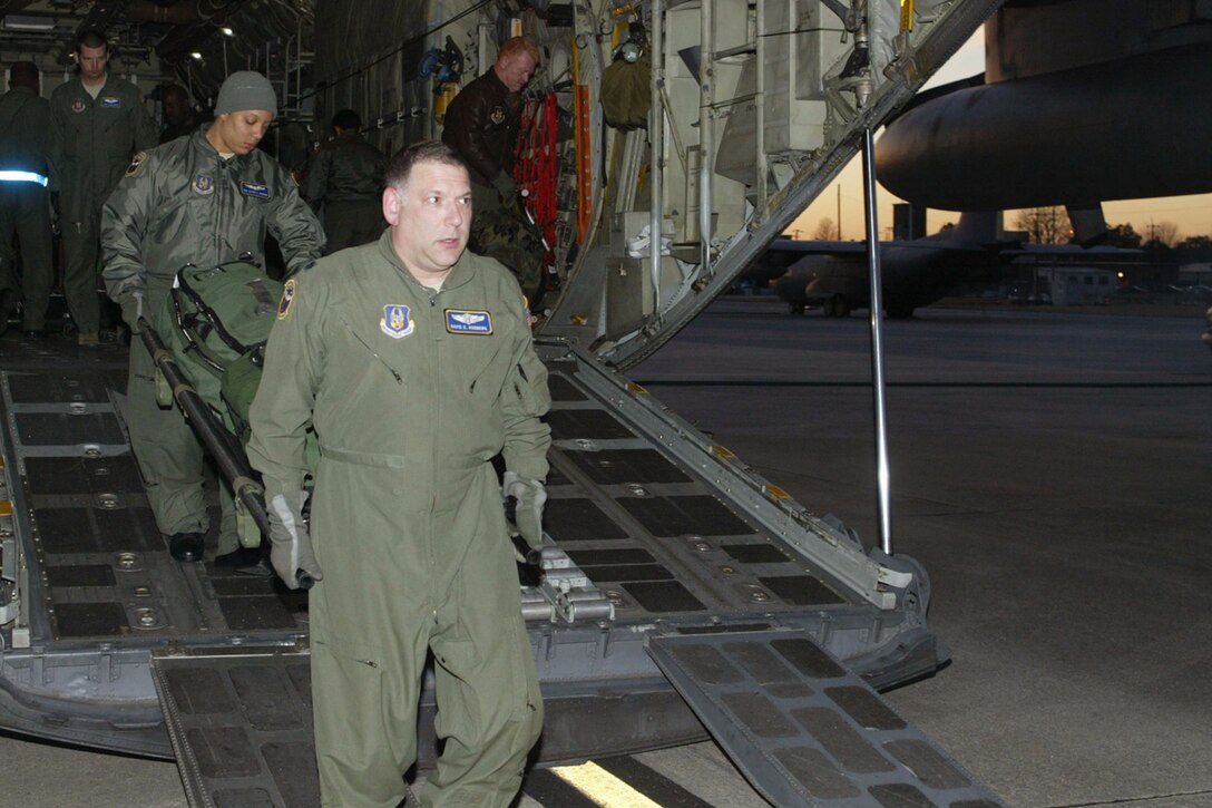 94th Aeromedical Evacuation Squadron members Lt. Col. David E. Rodberg, medical crew director, and Tech. Sgt. Alycia J. Jackson, medical technician, off load medical equipment Jan. 31 they used to provide critical assistance to Haitians. The crew returned from a two-week deployment in support of Operation Unified Response. (U.S. Air Force photo/Don Peek)