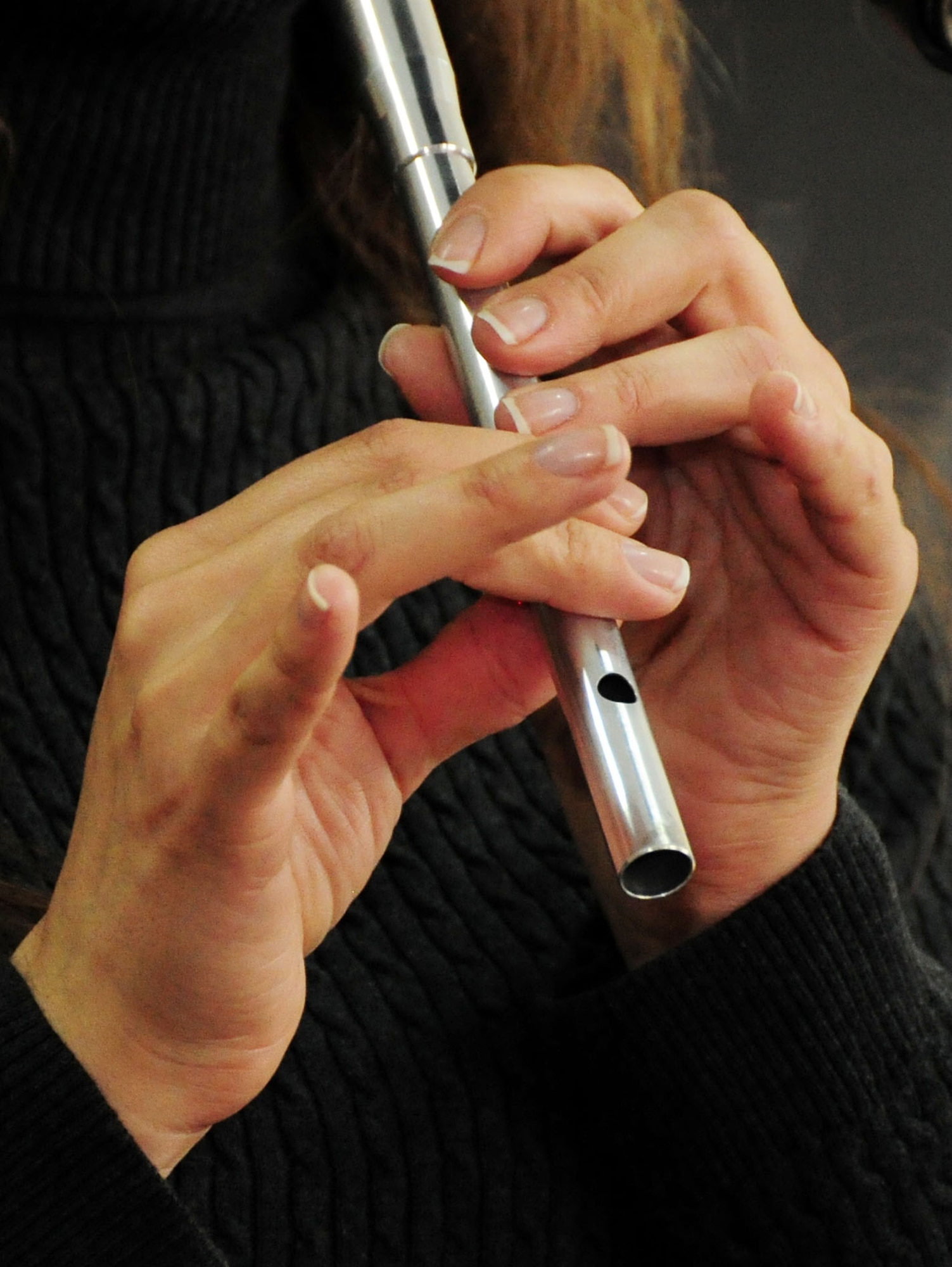 U.S. Air Force Tech. Sgt. Julia Brundage, vocalist and bodhran player for “Celtic Aire,” the U.S. Air Forces Central Public Affairs band, plays the penny whistle during a performance for the Police Academy students and instructors at the Academy in Bishkek, Kyrgyzstan, Jan. 28, 2010. (U.S. Air Force photo/Senior Airman Nichelle Anderson/released) 