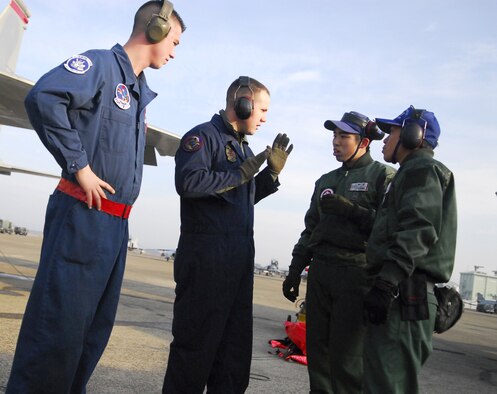 Senior Airman Dennis Crocker (left) and Staff Sgt. Chad Smith dicsuss pre-launch procedures with their counterparts from the Japan Air Self Defense Force Feb. 1. Two Airmen from the JASDF are working alongside American Airmen during the aviation training relocation at Hyakuri Air Base, about 70 miles north of Tokyo. (U.S. Air Force photo/1st Lt. Bryan Bouchard)