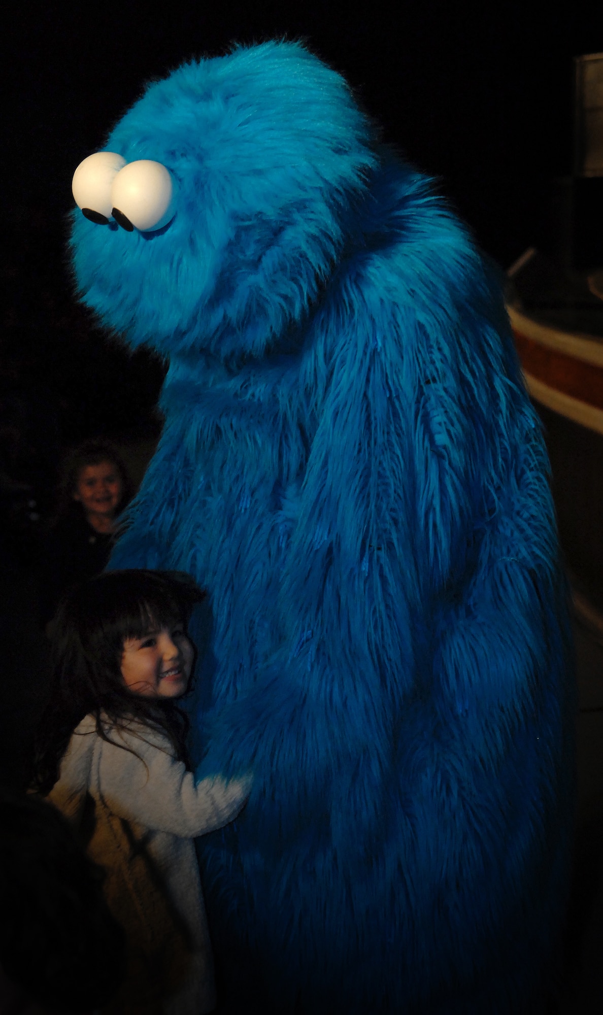 Cookie Monster shares a hug with children in the audience of the Sesame Street/United Service Organizations' Experience for Military Families show at Kadena's Keystone Theater Jan. 30. More than 1,600 people packed into the Keystone Theater for two free shows that highlighted community support for military families and helped children learn how to cope with stress associated with military life. Due to the overwhelming demand, the Sesame Workshop and USO will host two more performances at Camp Courtney's gym Feb. 3 at 3 and 6 p.m. (U.S. Air Force photo by Staff Sgt. Jason Lake)