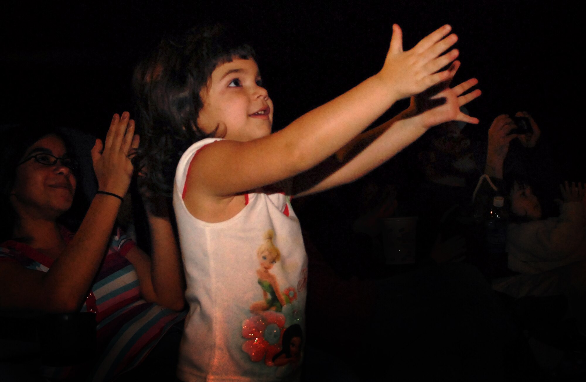 Isabelle Taylor, daughter of Staff Sgt. William Taylor from the 18th Communications Squadron, claps as Elmo, Cookie Monster, Rosita, Zoe and Grover perform during the Sesame Street/United Service Organizations' Experience for Military Families show Jan. 30. More than 1,600 people packed into the Keystone Theater for two free shows that highlighted community support for military families and helped children learn how to cope with stress associated with military life. Due to the overwhelming demand, Sesame Workshop and the USO will host two more shows at the Camp Courtney gym Feb. 3 at 3 and 6 p.m. (U.S. Air Force photo by Staff Sgt. Jason Lake)