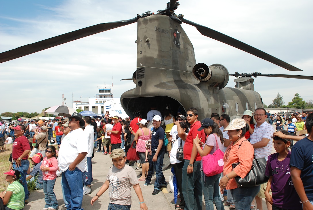 A crowd of spectators stand near a U.S. Army CH-47 Chinook to watch the 2010 Ilopango Air Show in Ilopango El Salvador, Jan. 30. The U.S. military participated in the air show with an HH-60 Black Hawk and a CH-47 Chinook from Joint Task Force-Bravo, Soto Cano Air Base, Honduras, along with two U.S. Air Force B-1B Lancers from the 7th Bomb Wing, Dyess Air Force Base, Texas, drawings crowds of approximately 18,000 people to the air show Jan. 30-31. (U.S. Air Force photo by 1st Lt. Jen Richard)