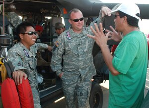 U.S. Army Specialist Bryan Fulgado and Sgt. Daniel Kreth, HH-60 Black Hawk crew members, talk with a Salvadoran spectator at the helicopter's static display during the 2010 Ilopango Air Show in Ilopango, El Salvador, Jan. 30. The U.S. military supported the air show with an HH-60 Black Hawk and a CH-47 Chinook from Joint Task Force-Bravo, Soto Cano Air Base, Honduras, along with two U.S. Air Force B-1B Lancers from the 7th Bomb Wing, Dyess Air Force Base, Texas. (U.S. Air Force photo by 1st Lt. Jen Richard) 